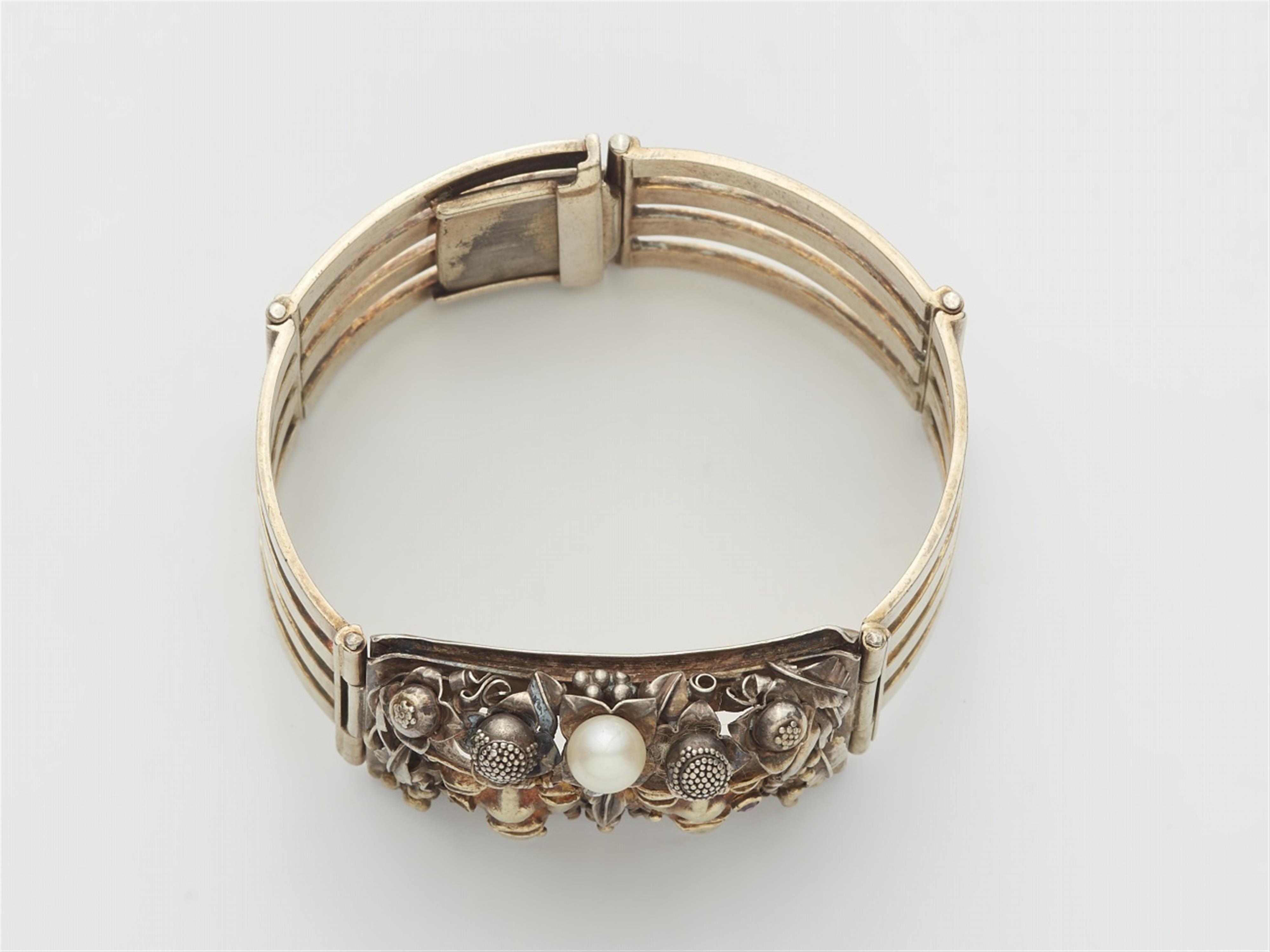 A silver gilt bracelet with a mask - image-2