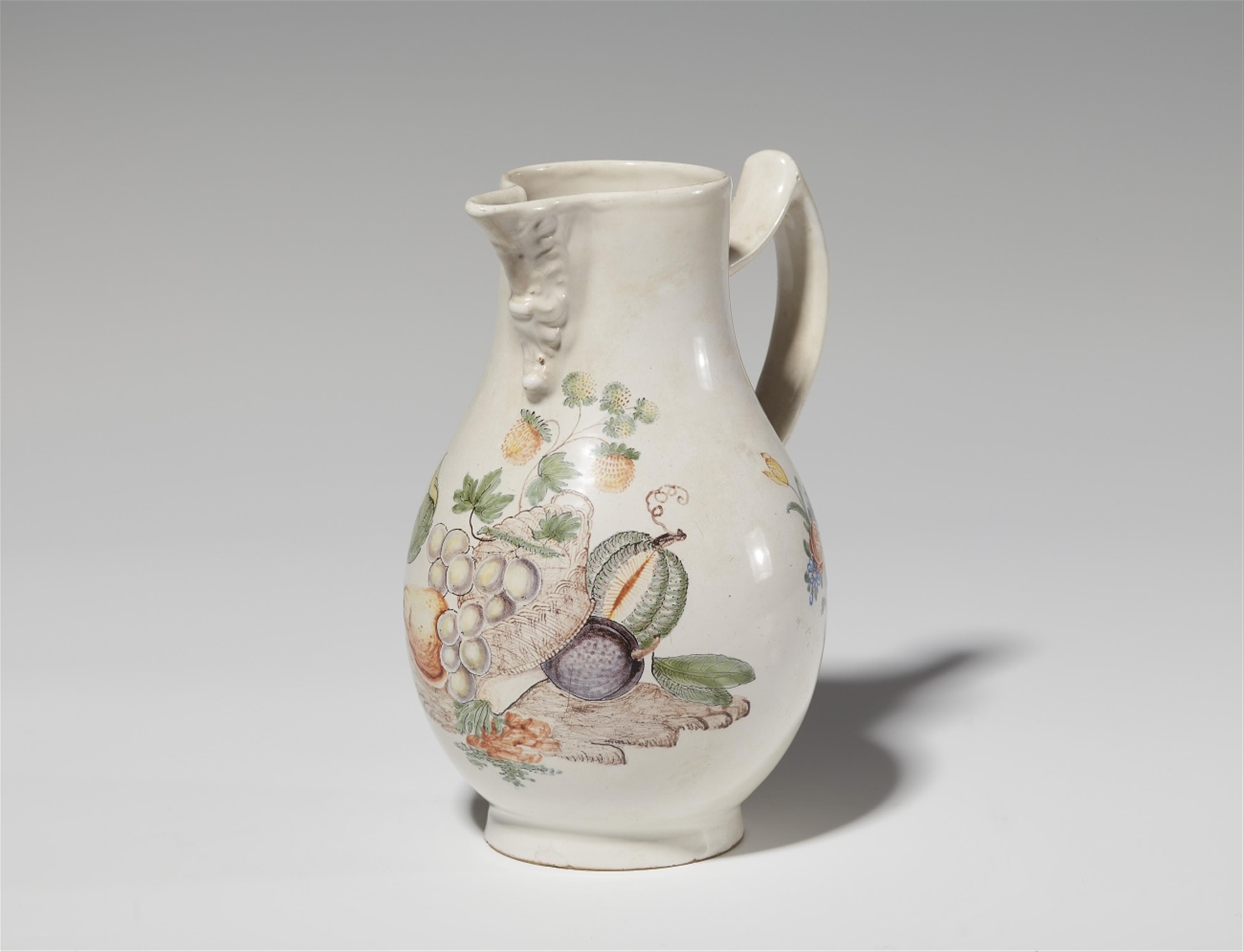 A faience pitcher with a basket of fruit - image-1
