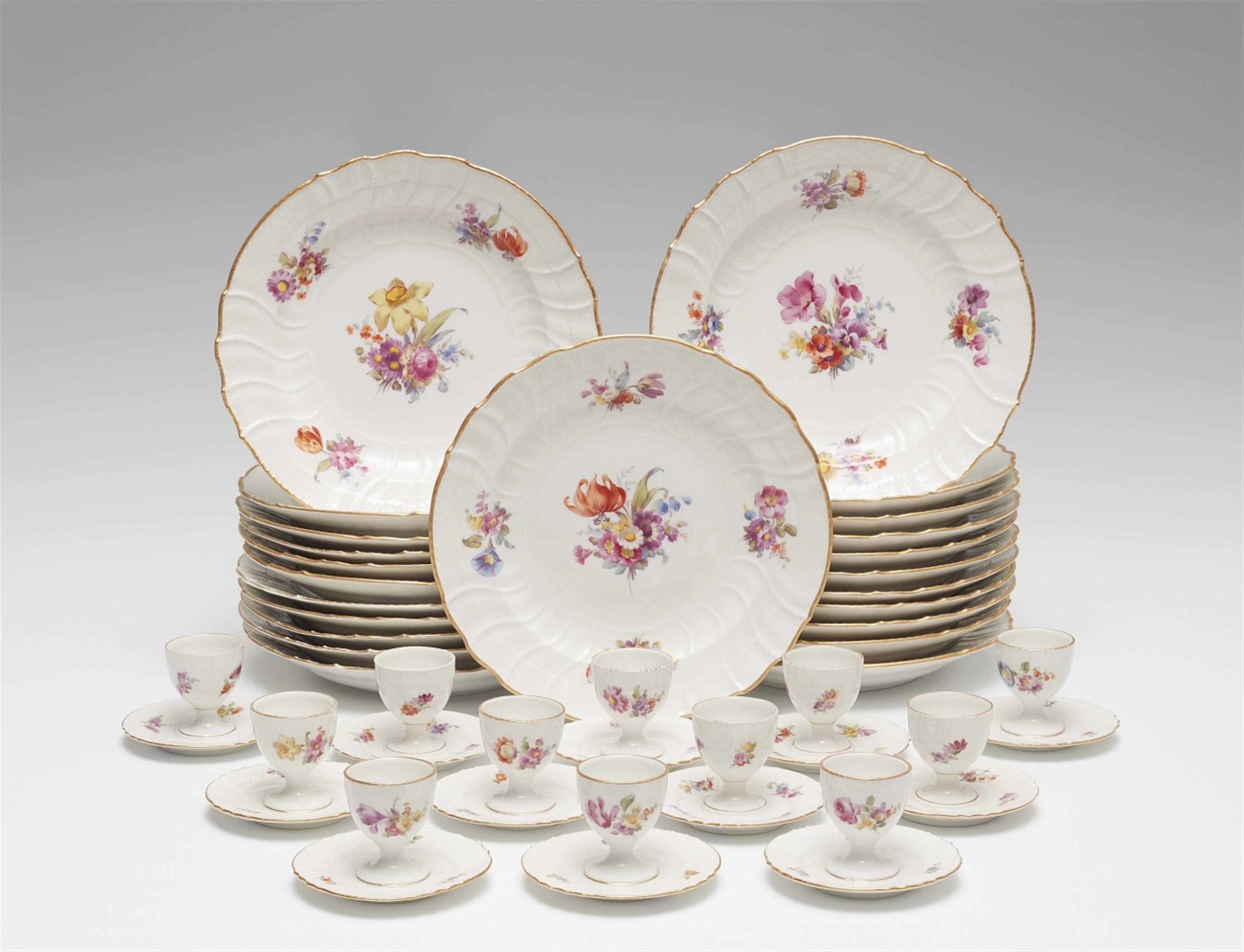 Twenty three Berlin KPM porcelain dinner plates and twelve egg cups with floral decor - image-1