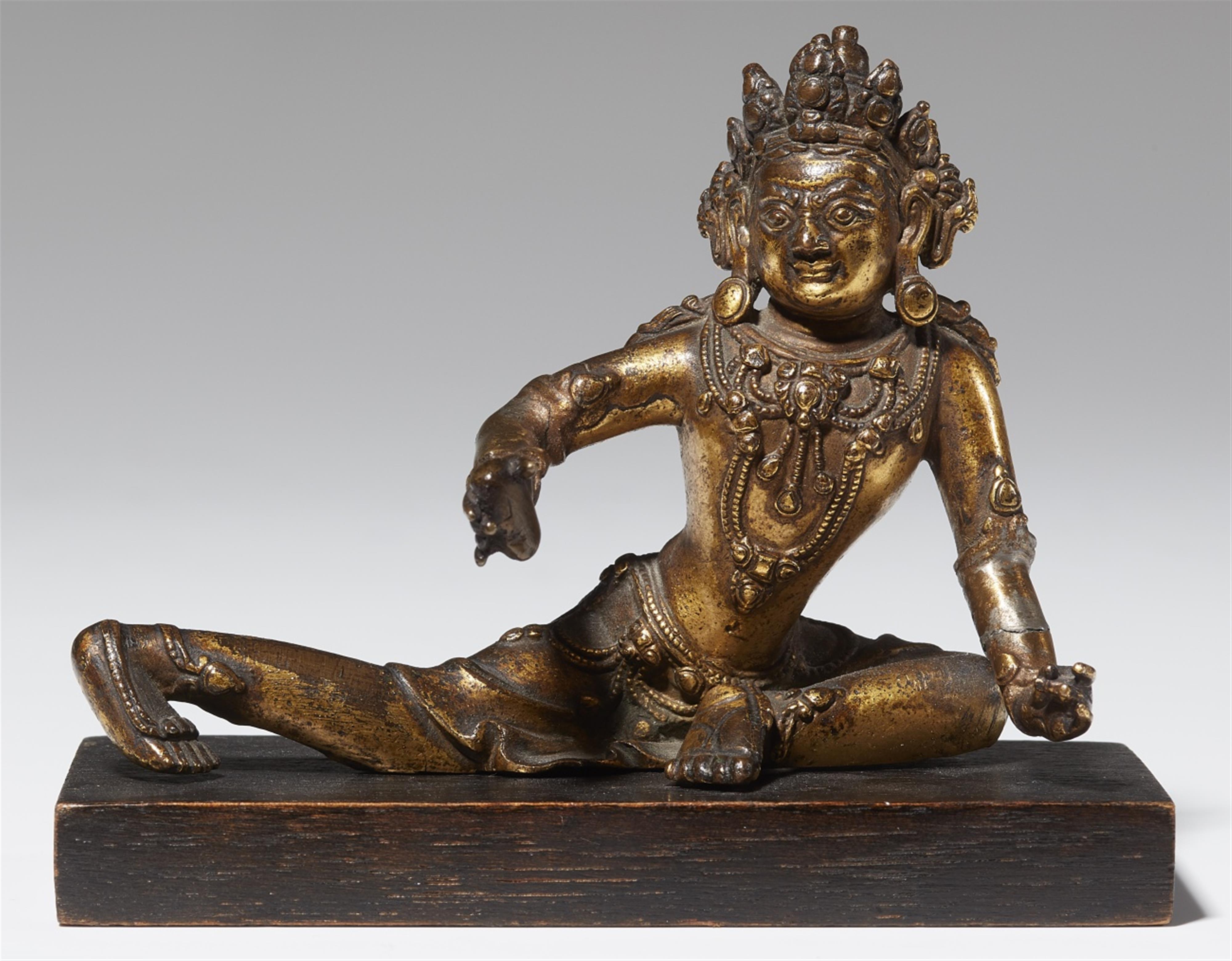 A Tibetan gilt bronze figure of a deity. 16th century - image-1