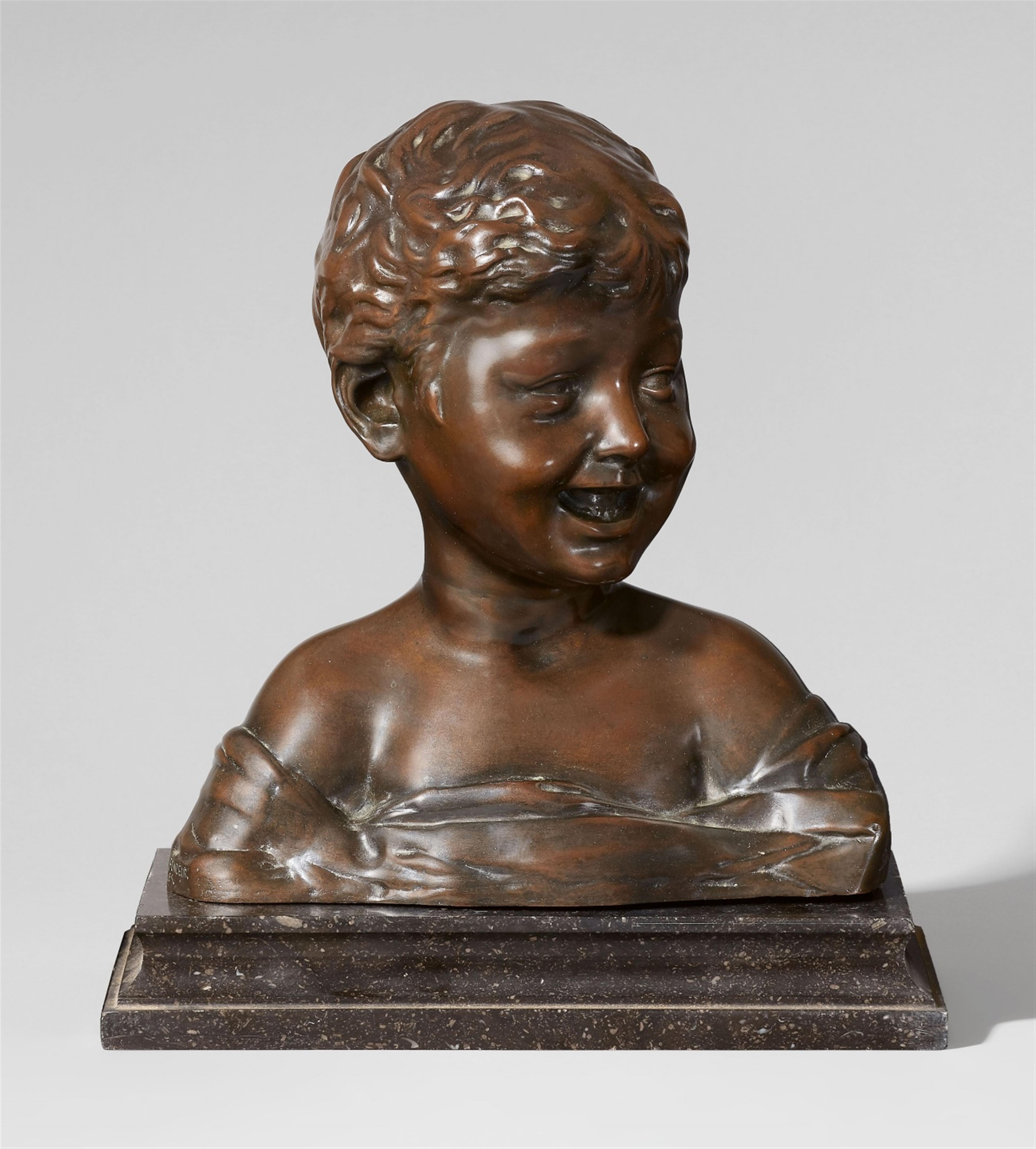 A bronze model of a laughing boy - image-1