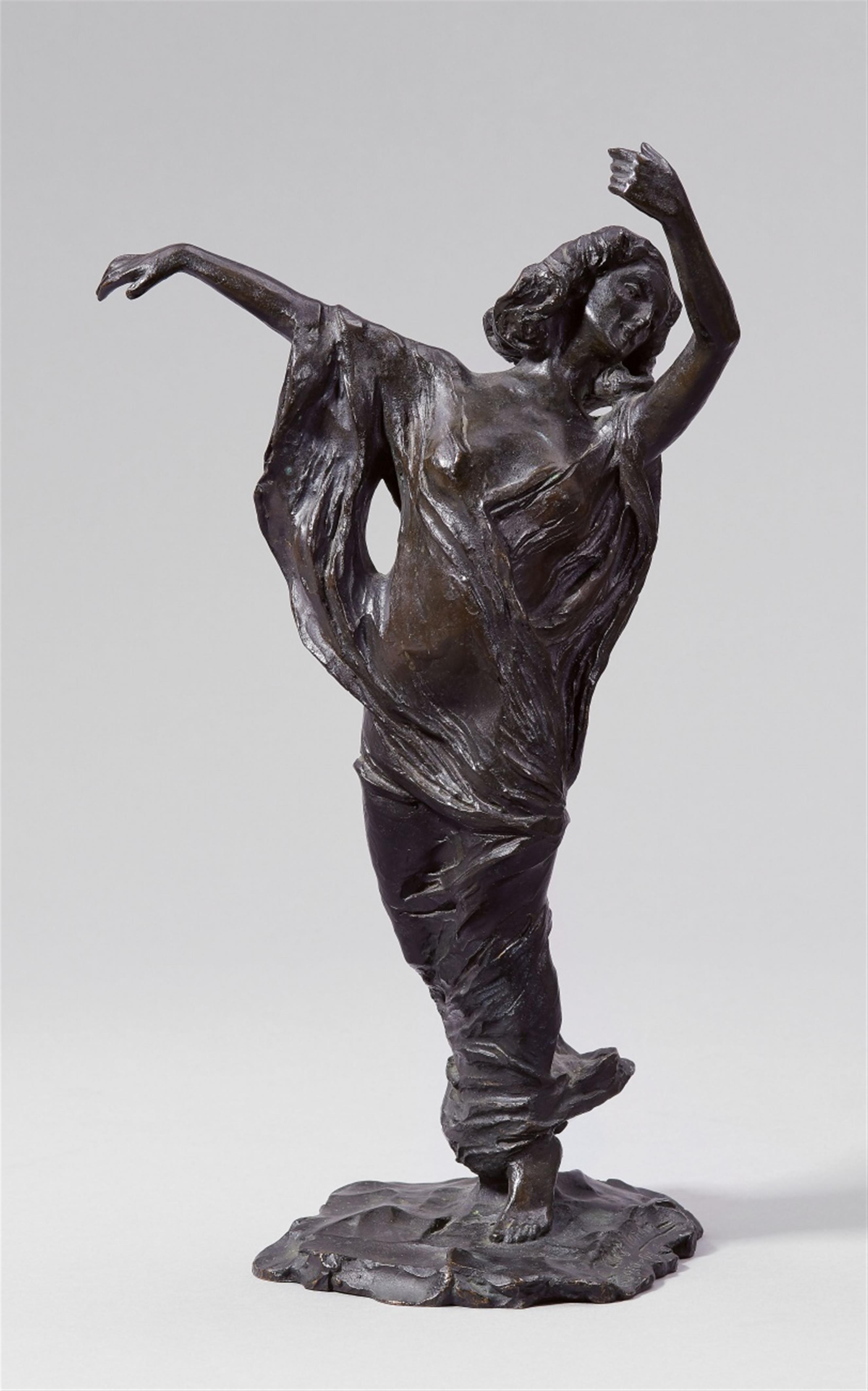 A bronze figure of a veil dancer - image-1