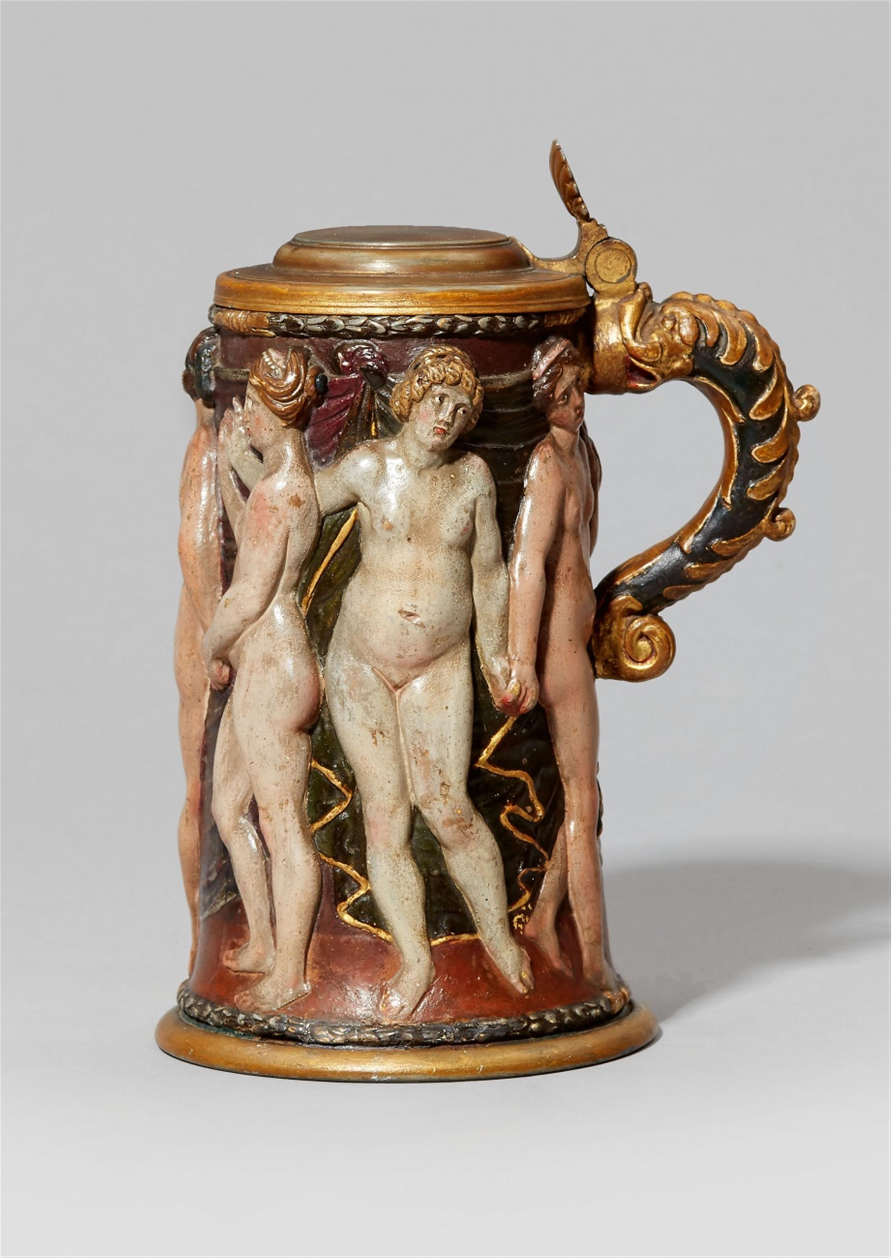 An unusual earthenware tankard with a figural relief - image-1