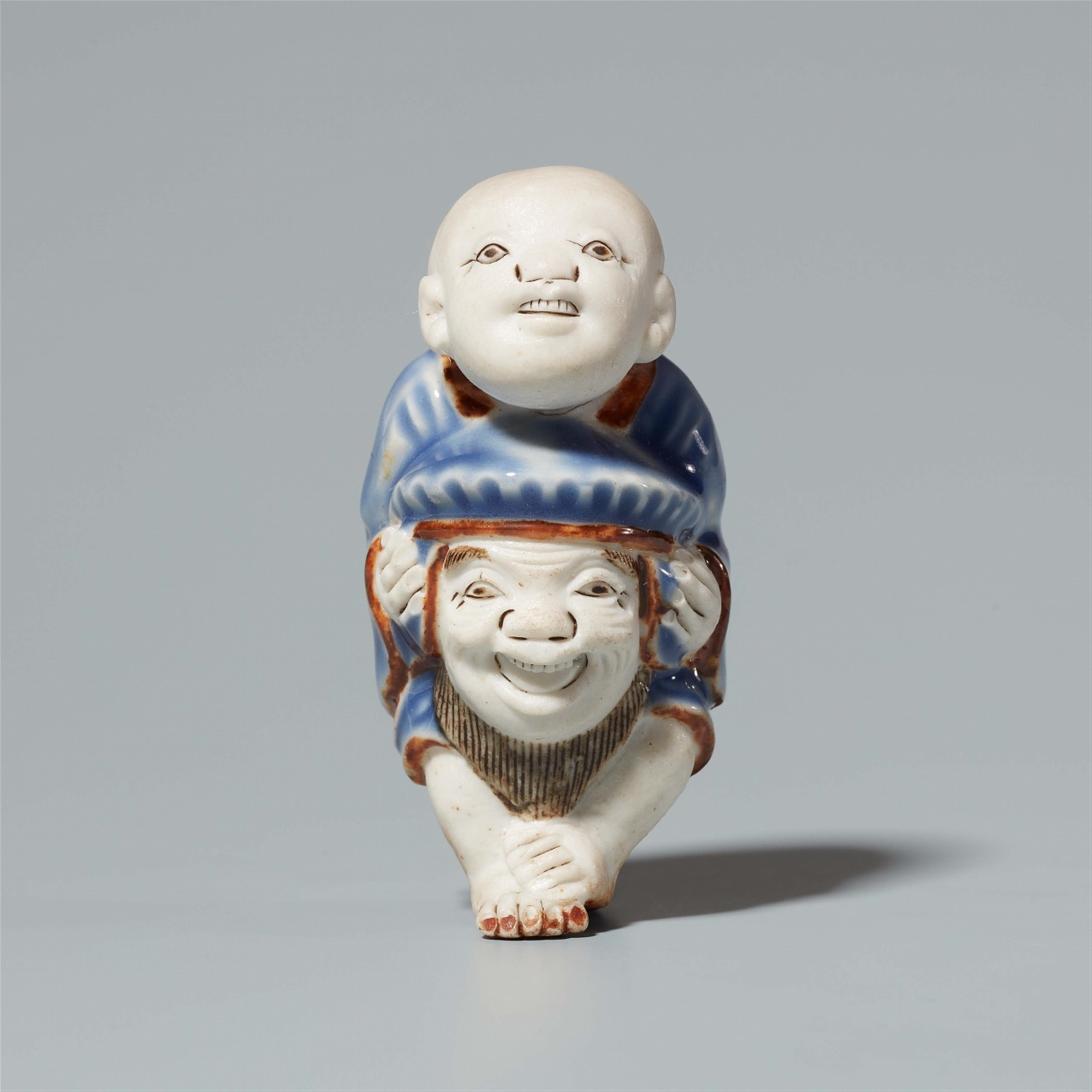 A porcelain netsuke of a karako with a mask. Around 1900 - image-1