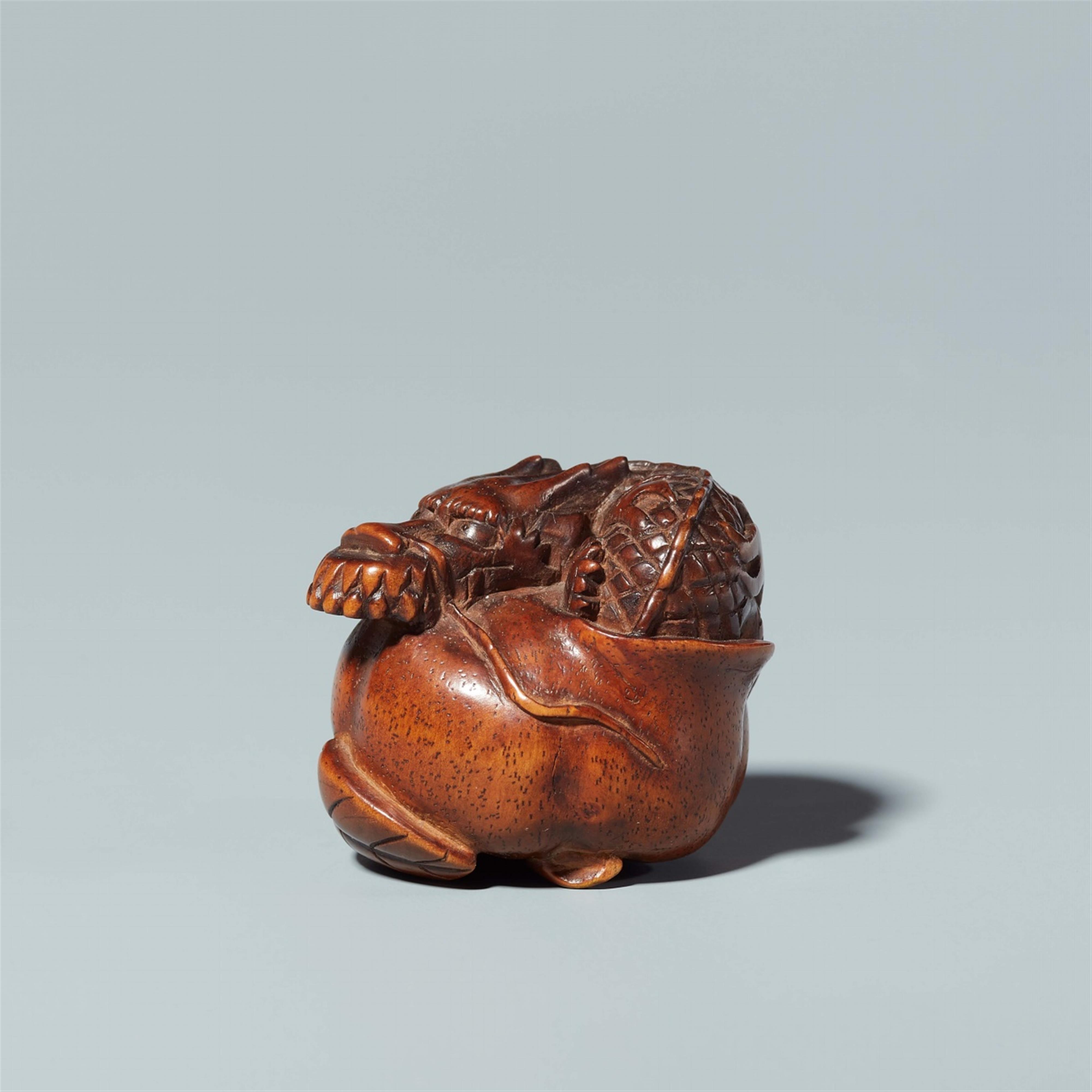 A wood netsuke of a dragon in a fruit. 19th century - image-1