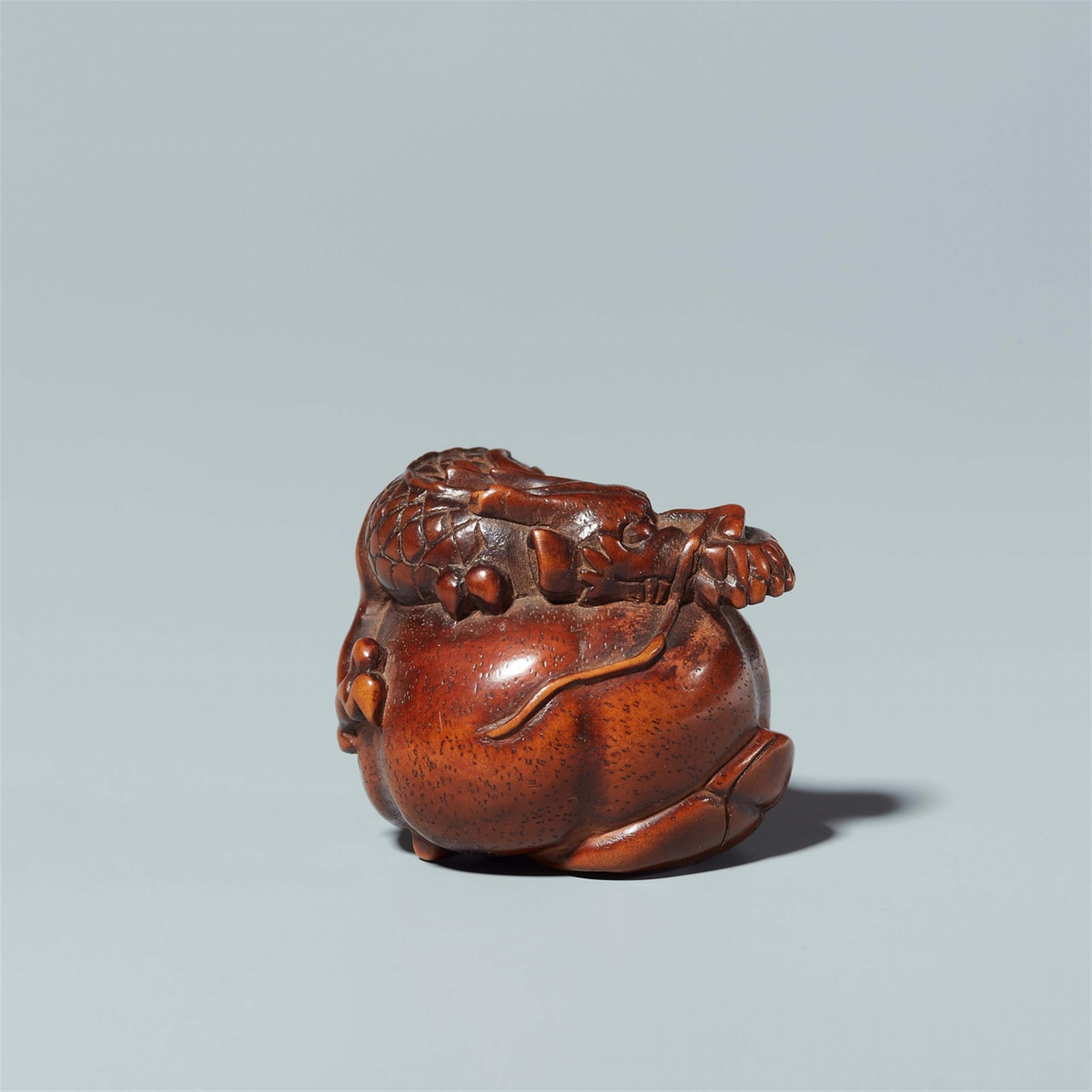 A wood netsuke of a dragon in a fruit. 19th century - image-2
