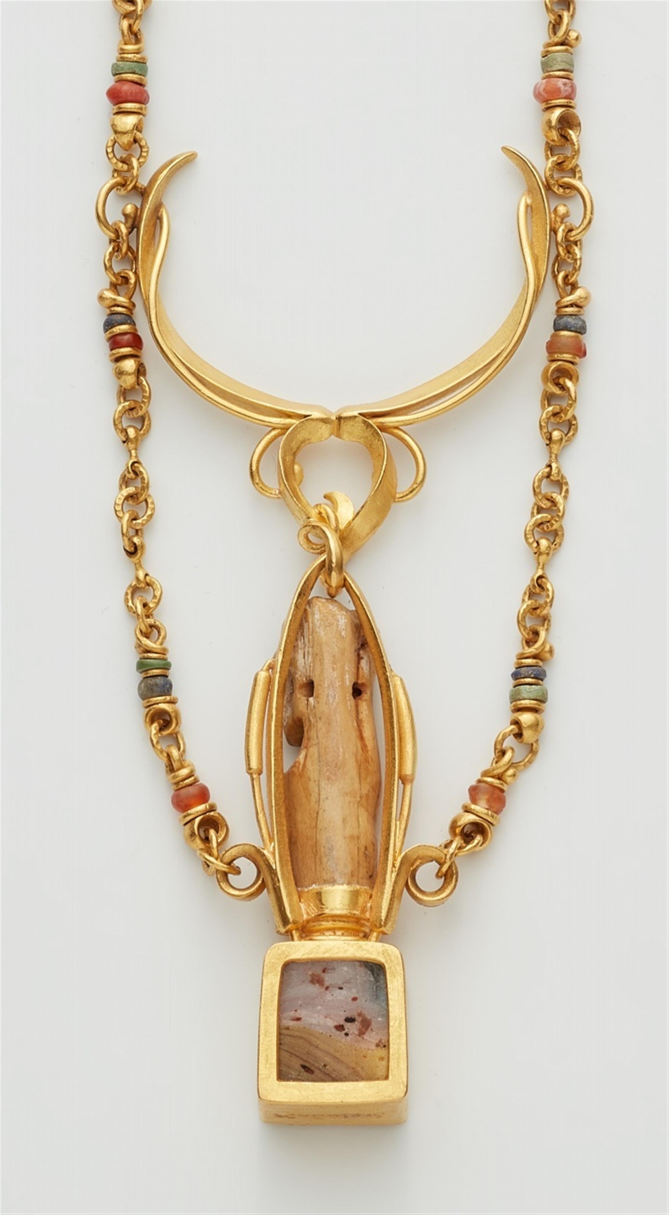 A 22k gold necklace with an Egyptian amulet - image-3