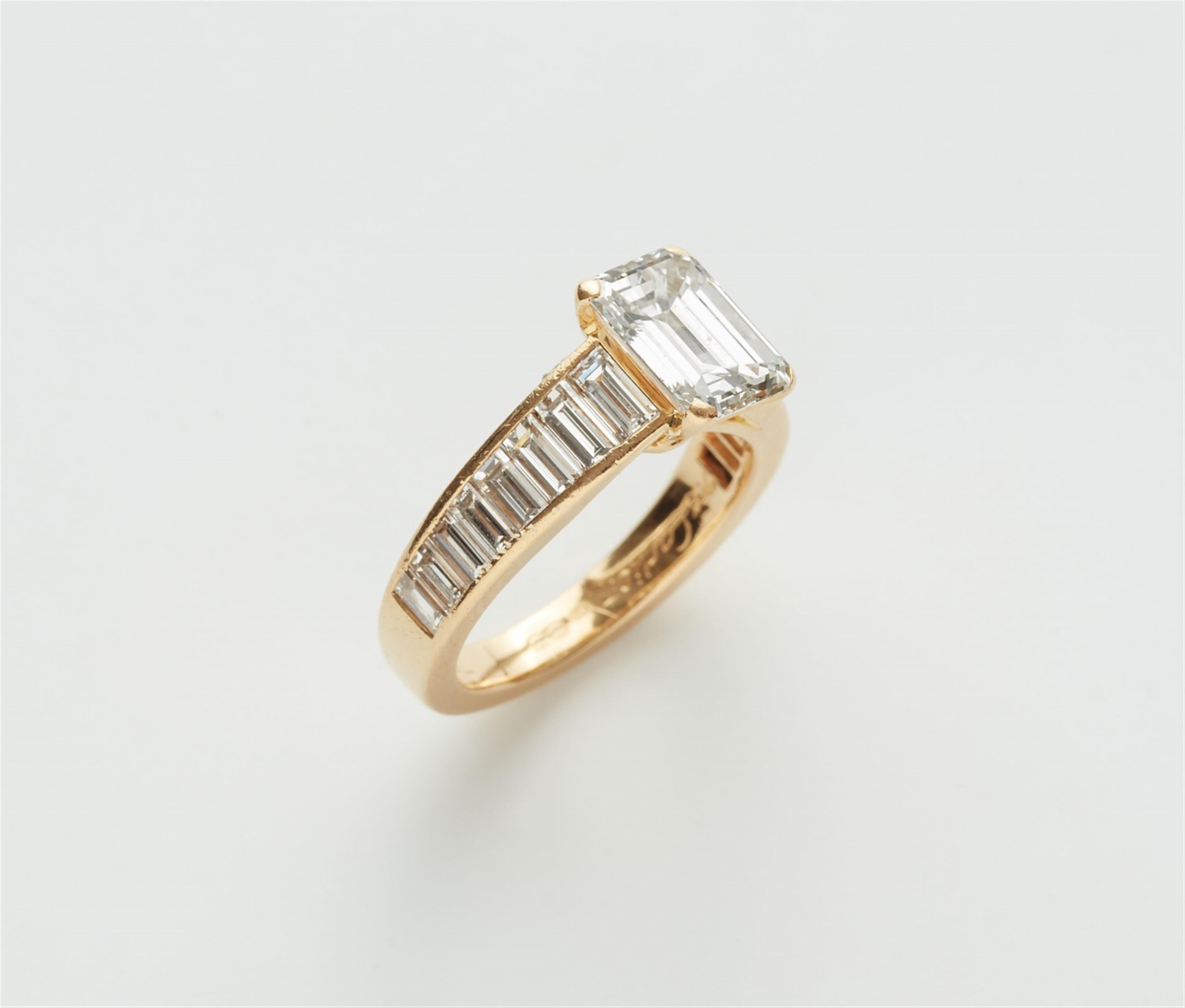 An 18k gold Cartier ring with an emerald-cut diamond solitaire - image-2