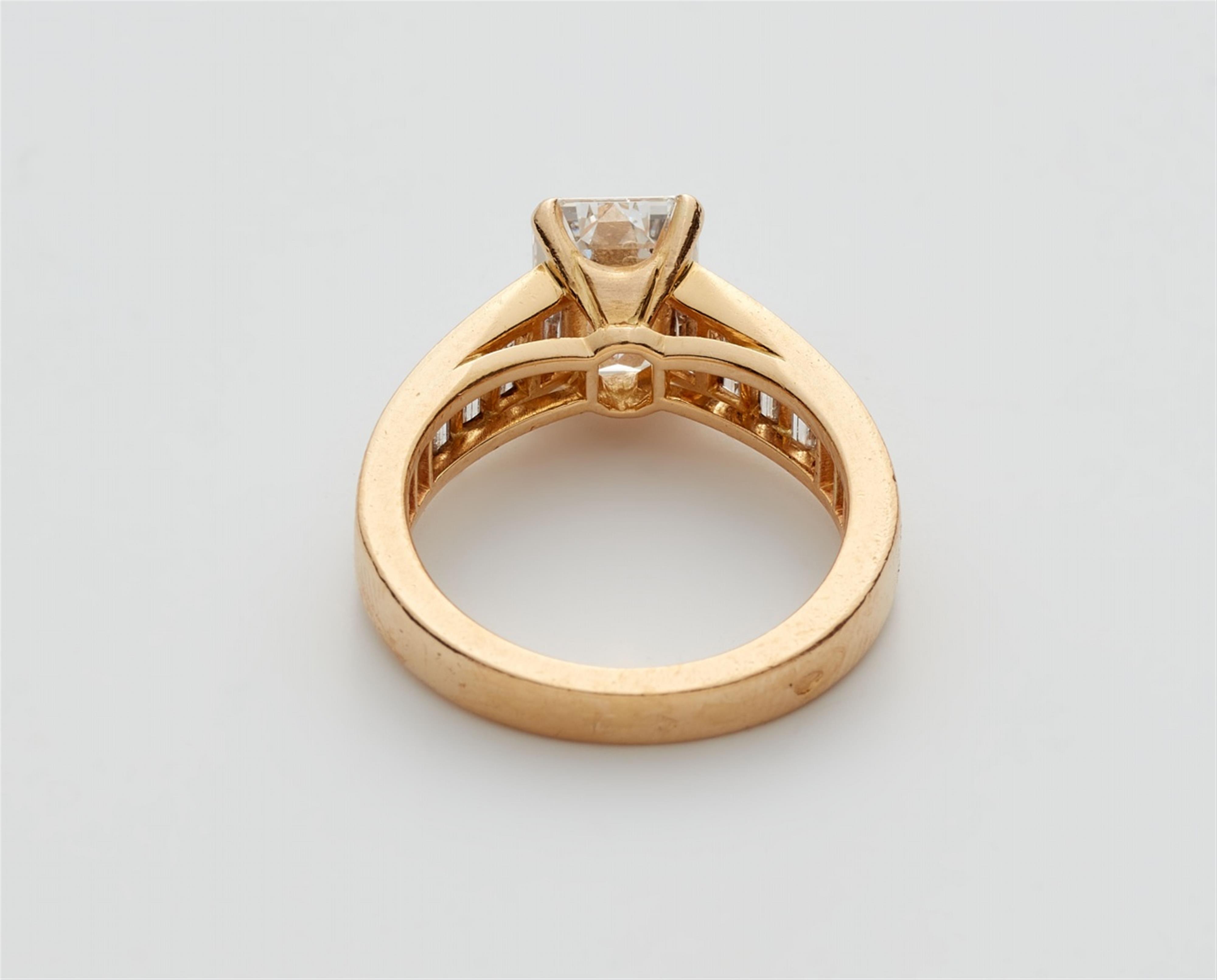An 18k gold Cartier ring with an emerald-cut diamond solitaire - image-3