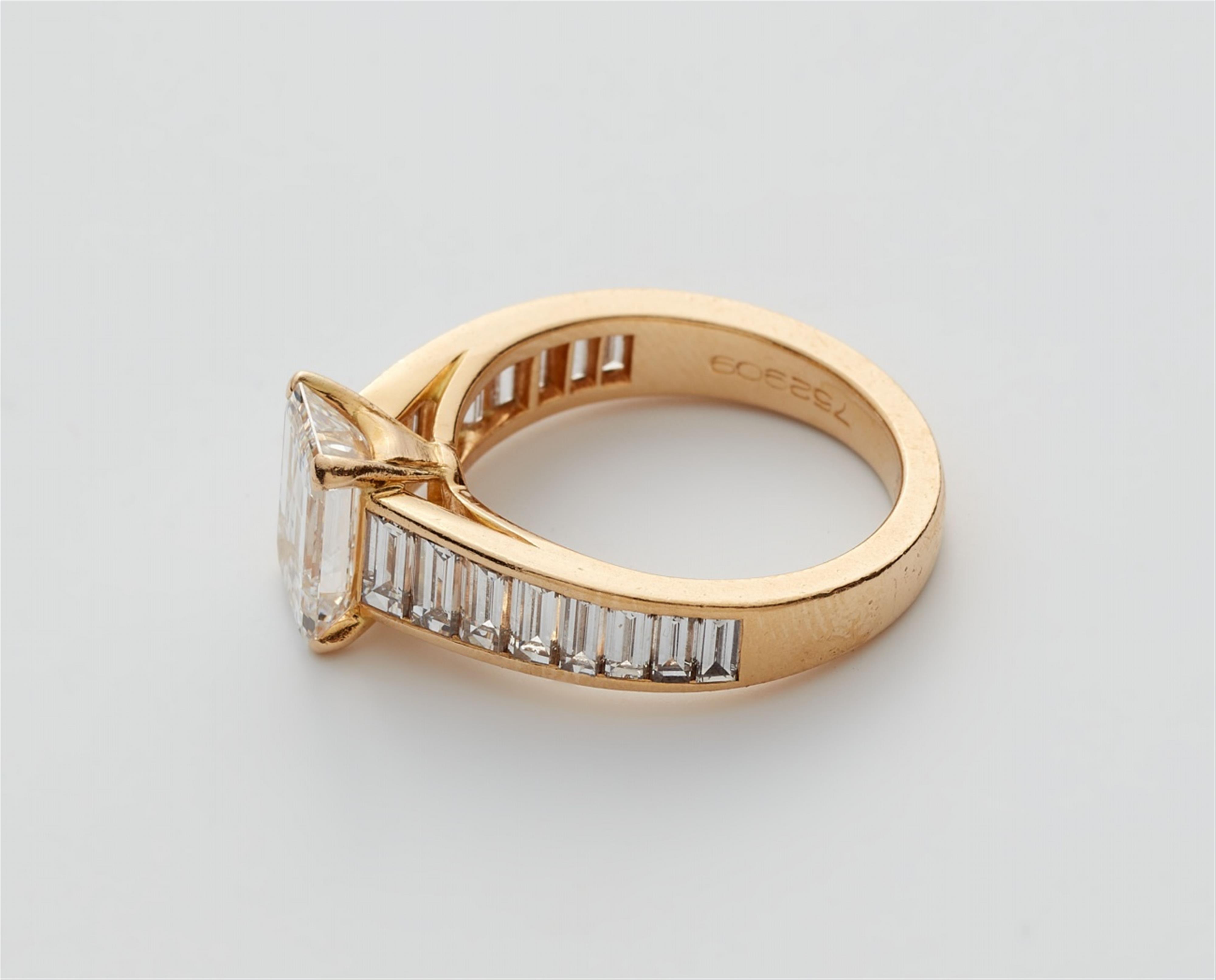 An 18k gold Cartier ring with an emerald-cut diamond solitaire - image-4