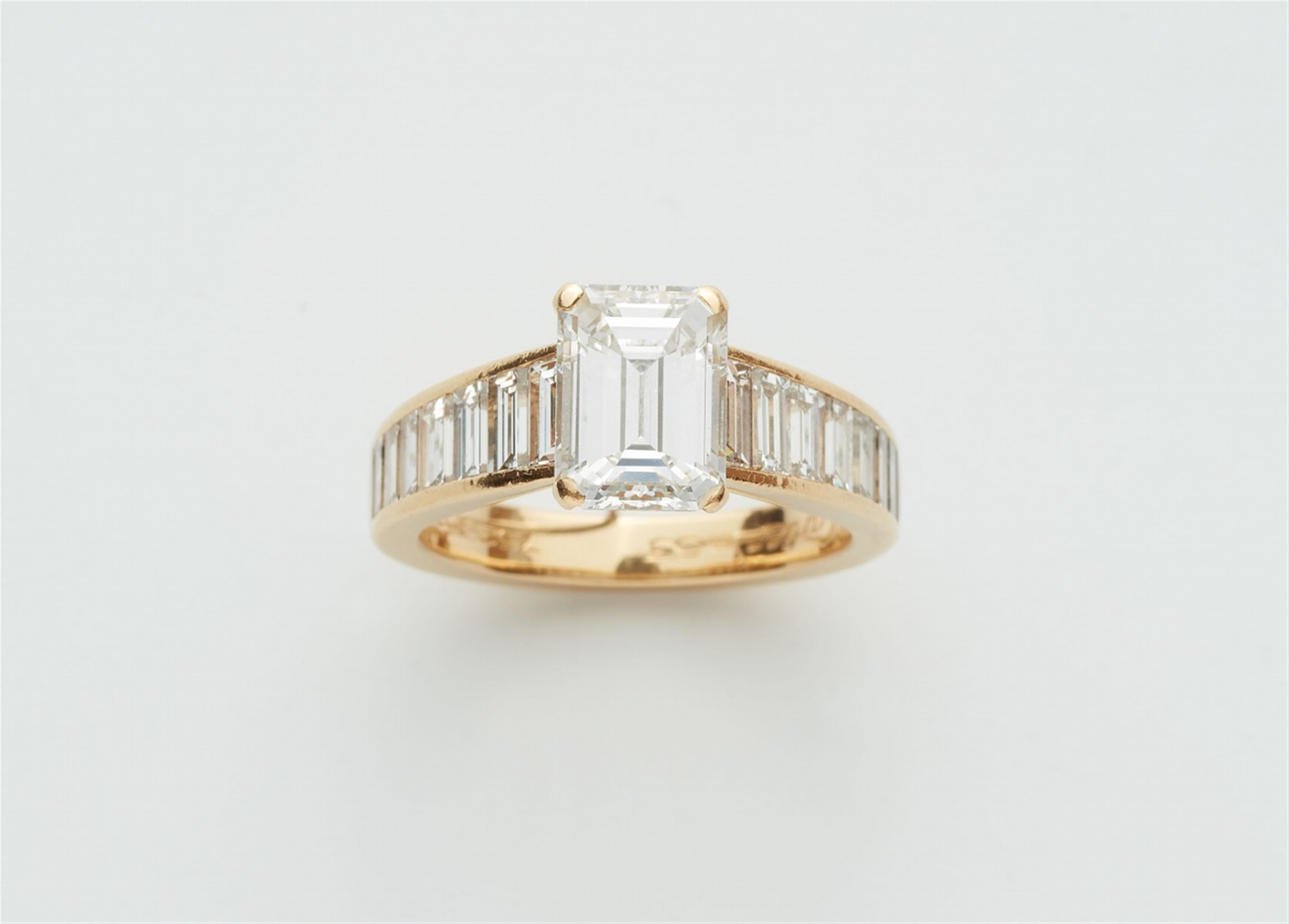 An 18k gold Cartier ring with an emerald-cut diamond solitaire - image-1