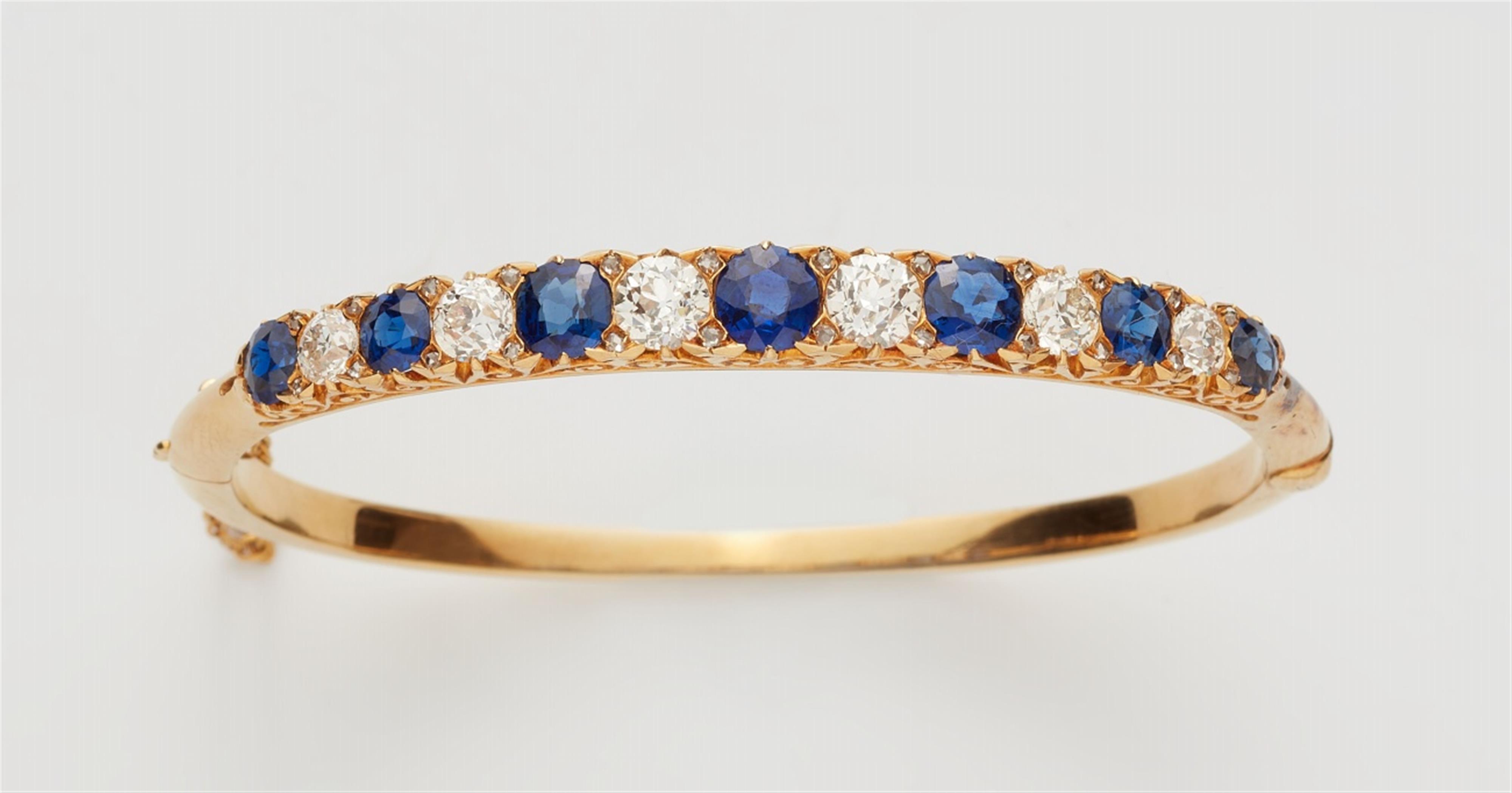 A Belle Epoque 14k gold sapphire and diamond bangle - image-1
