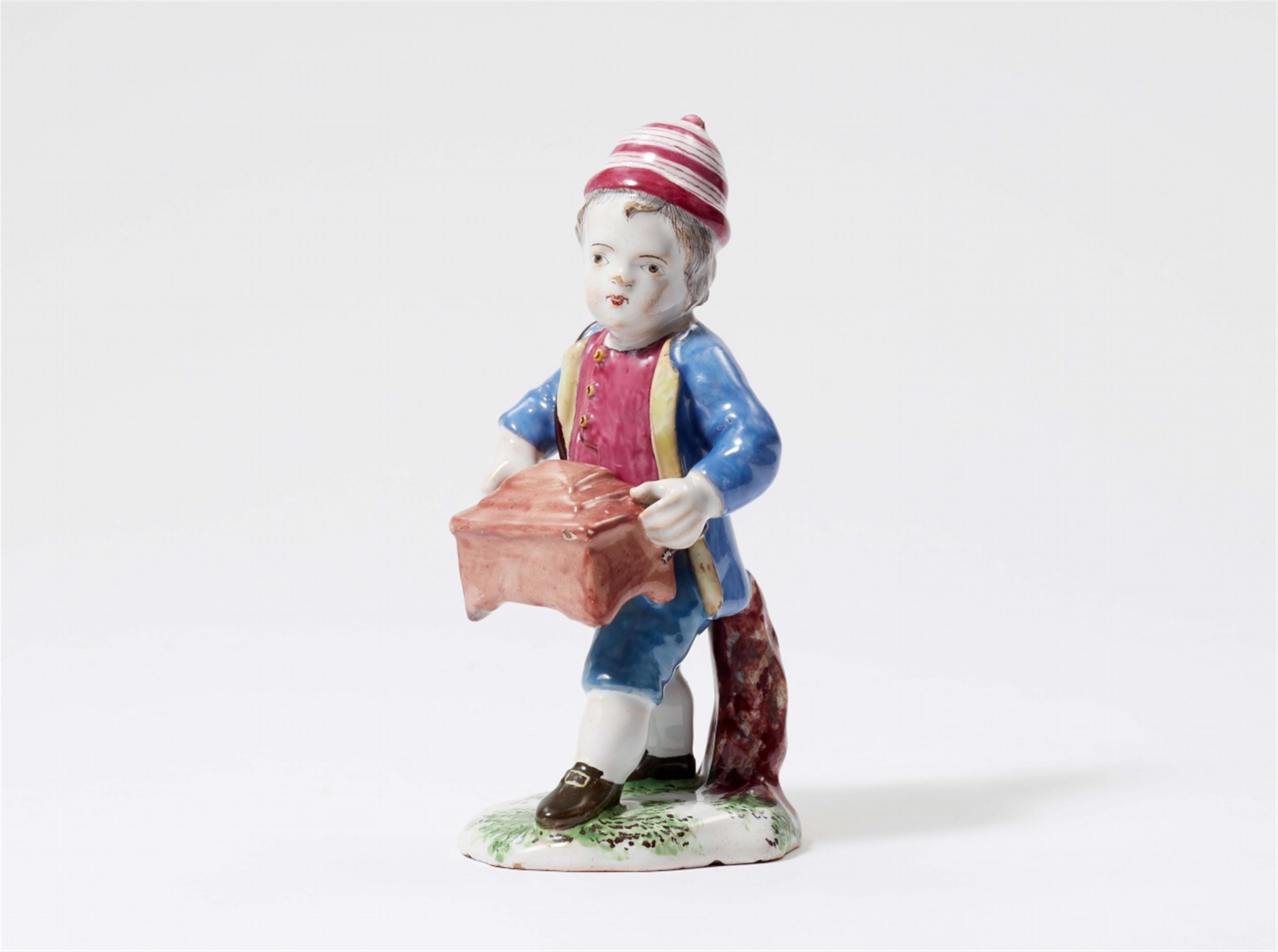 A rare Strasbourg faience figure of a boy with a barrel organ - image-1