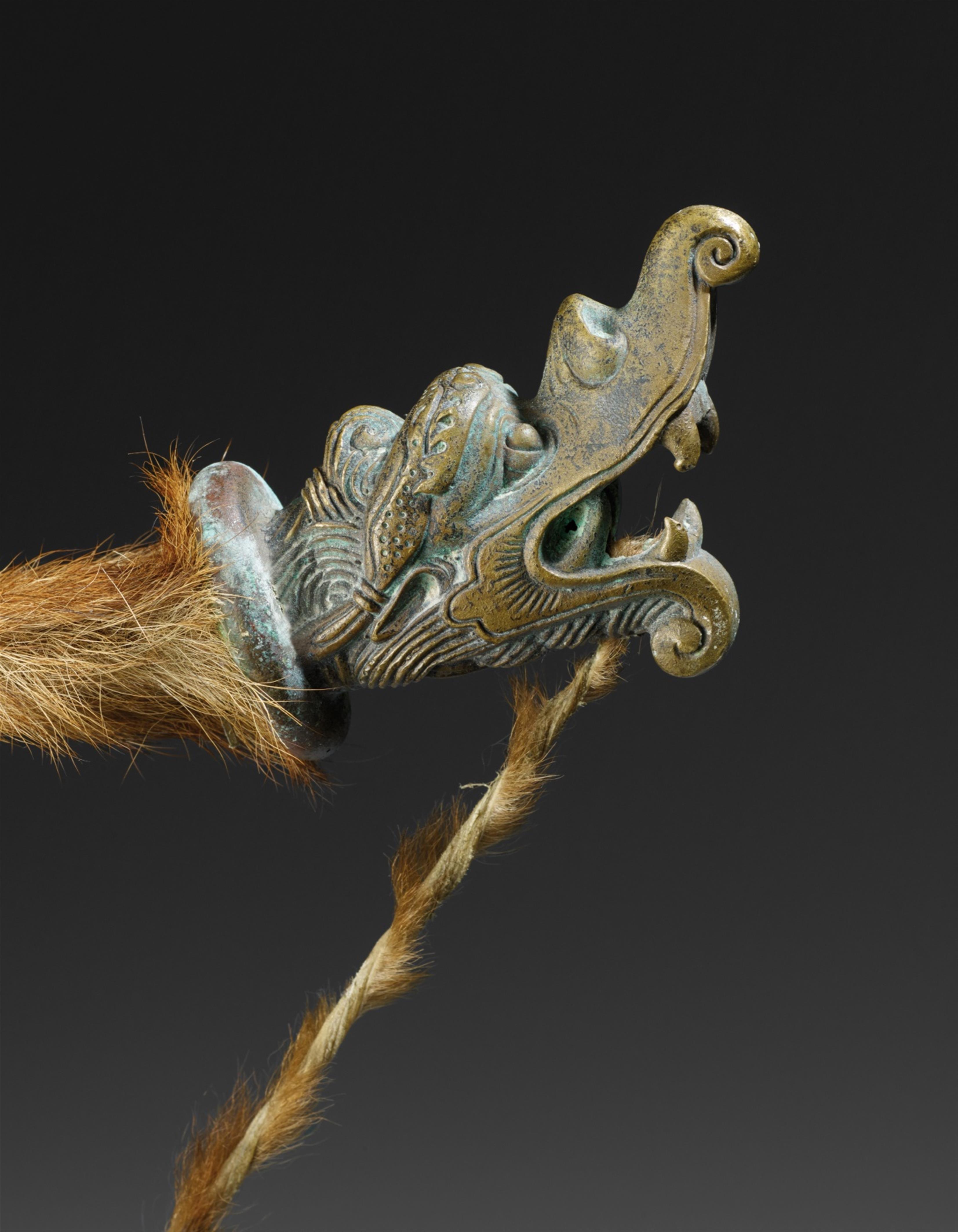 A brass bow with animal fur - image-2