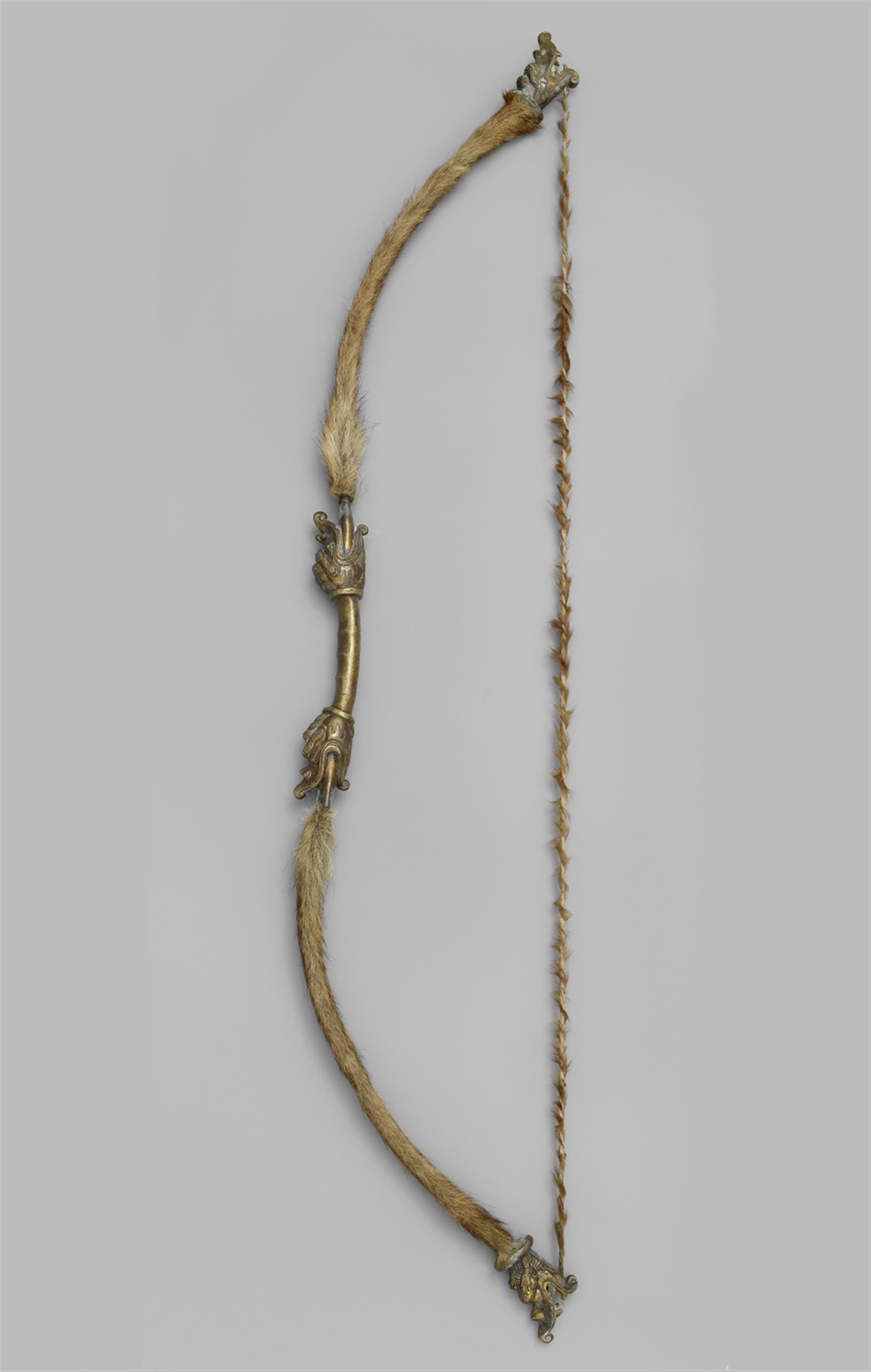 A brass bow with animal fur - image-4