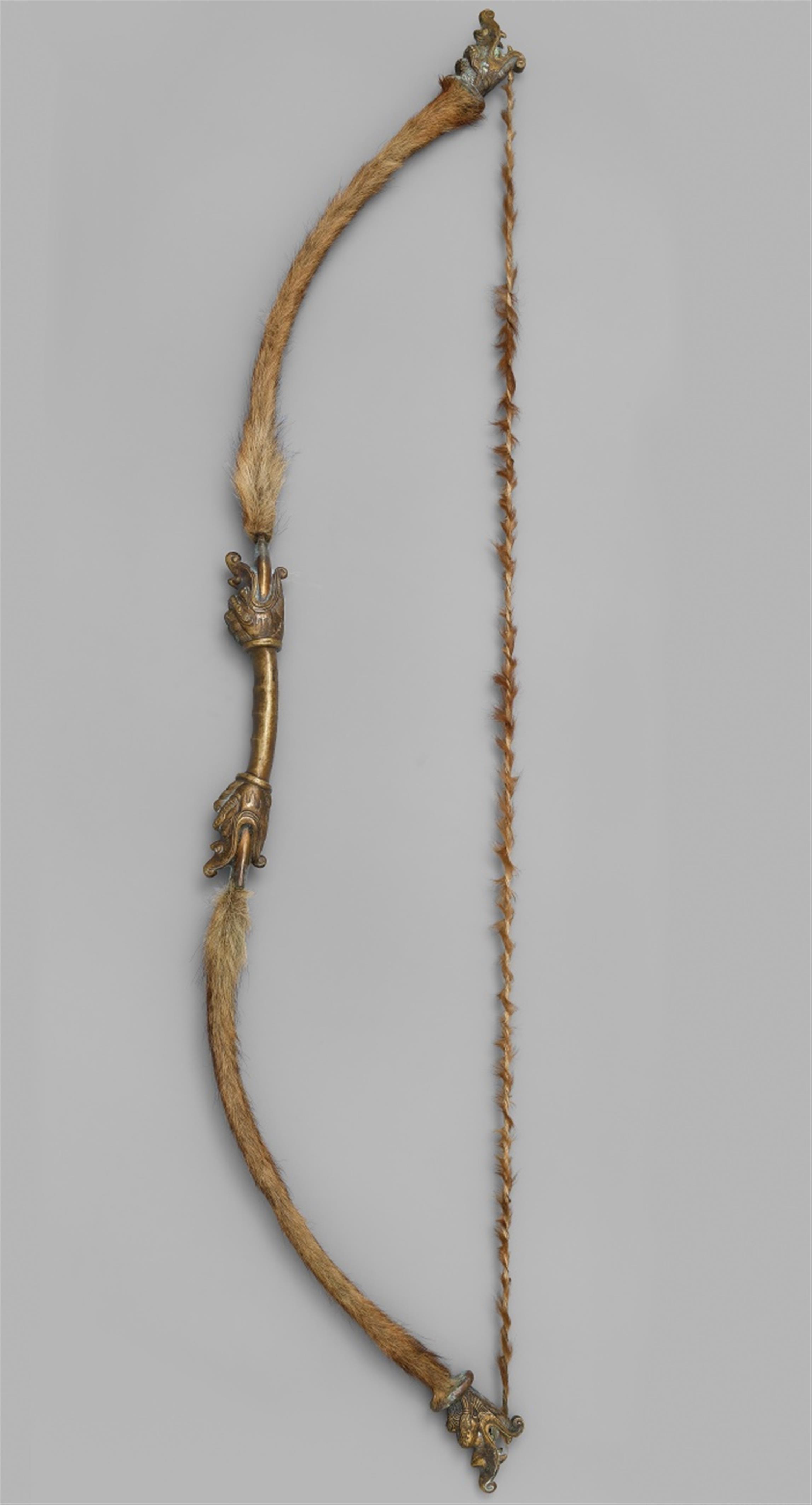 A brass bow with animal fur - image-1
