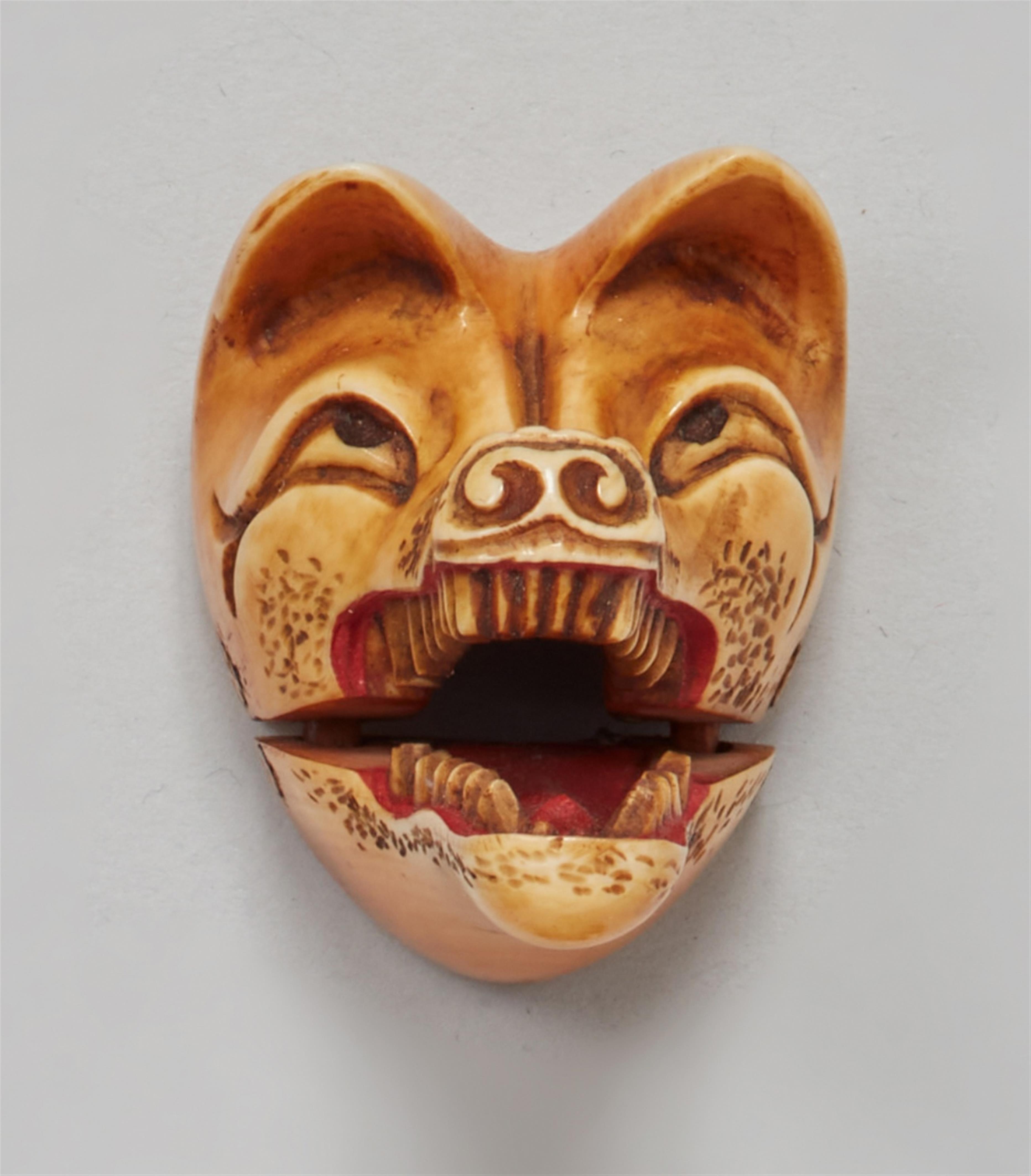 A stained ivory netsuke of a Kitsune mask. 19th century - image-1