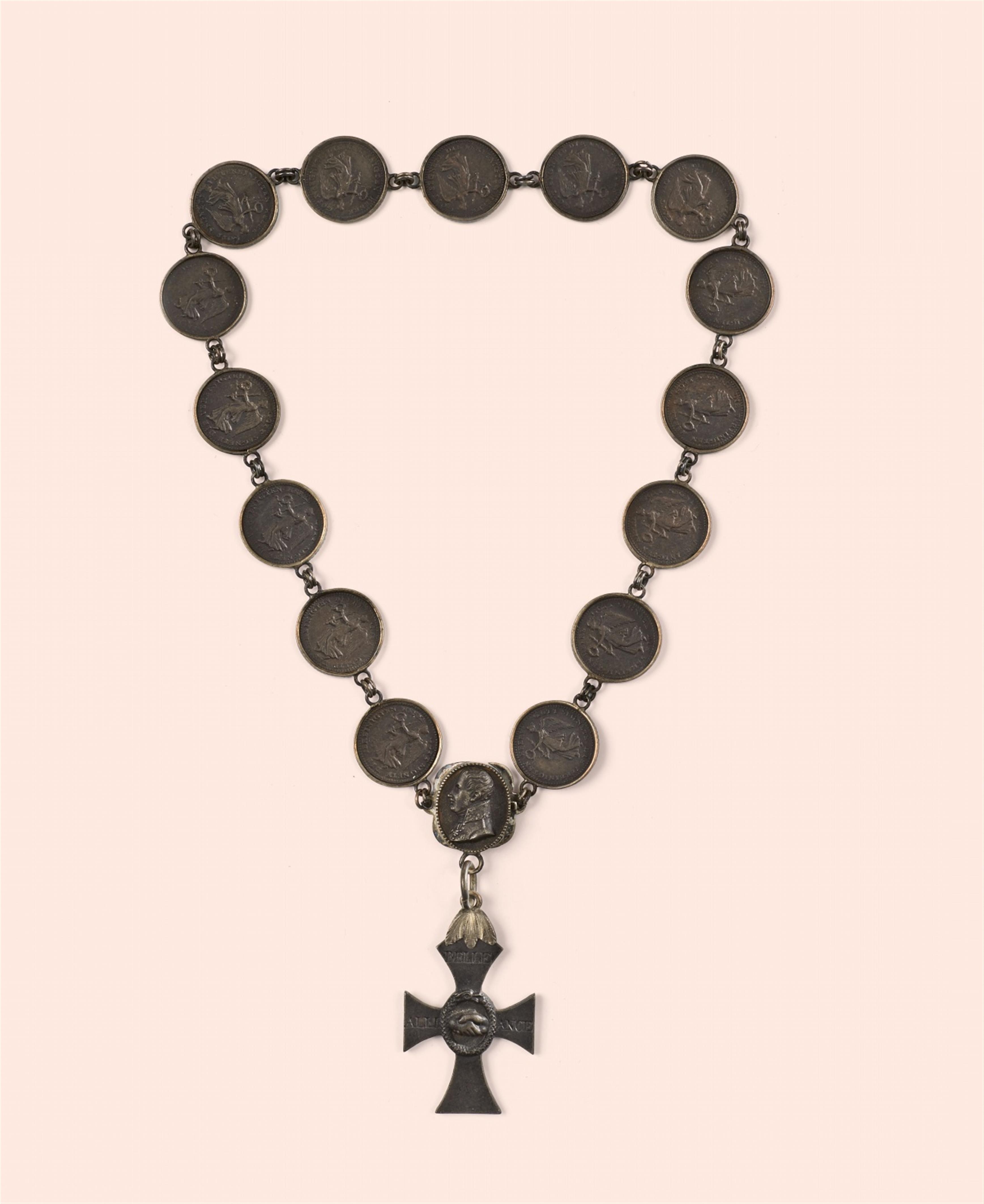 A cast iron necklace with commemorative medallions and a cross pendant - image-1