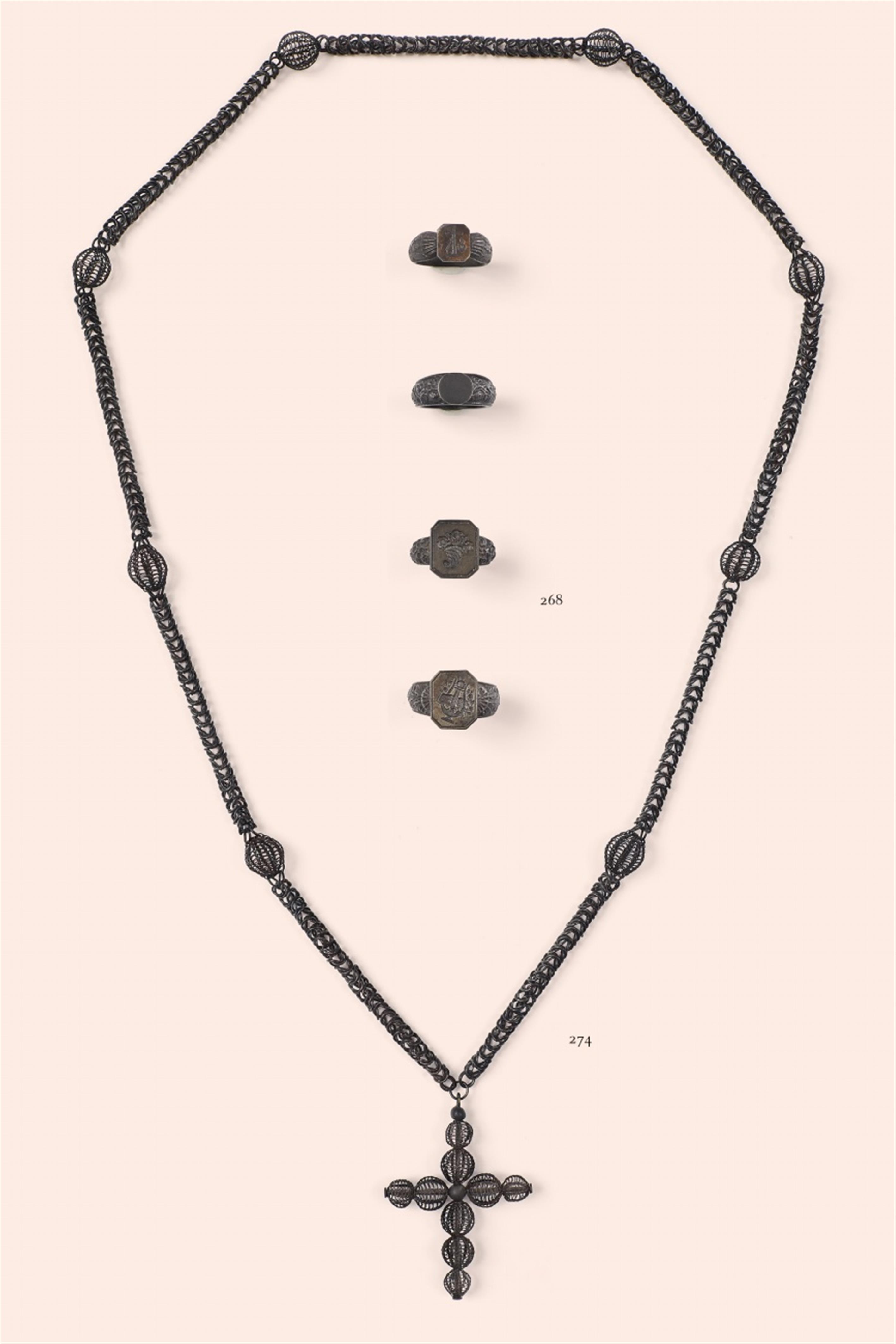 A cast iron necklace with a cross pendant - image-1