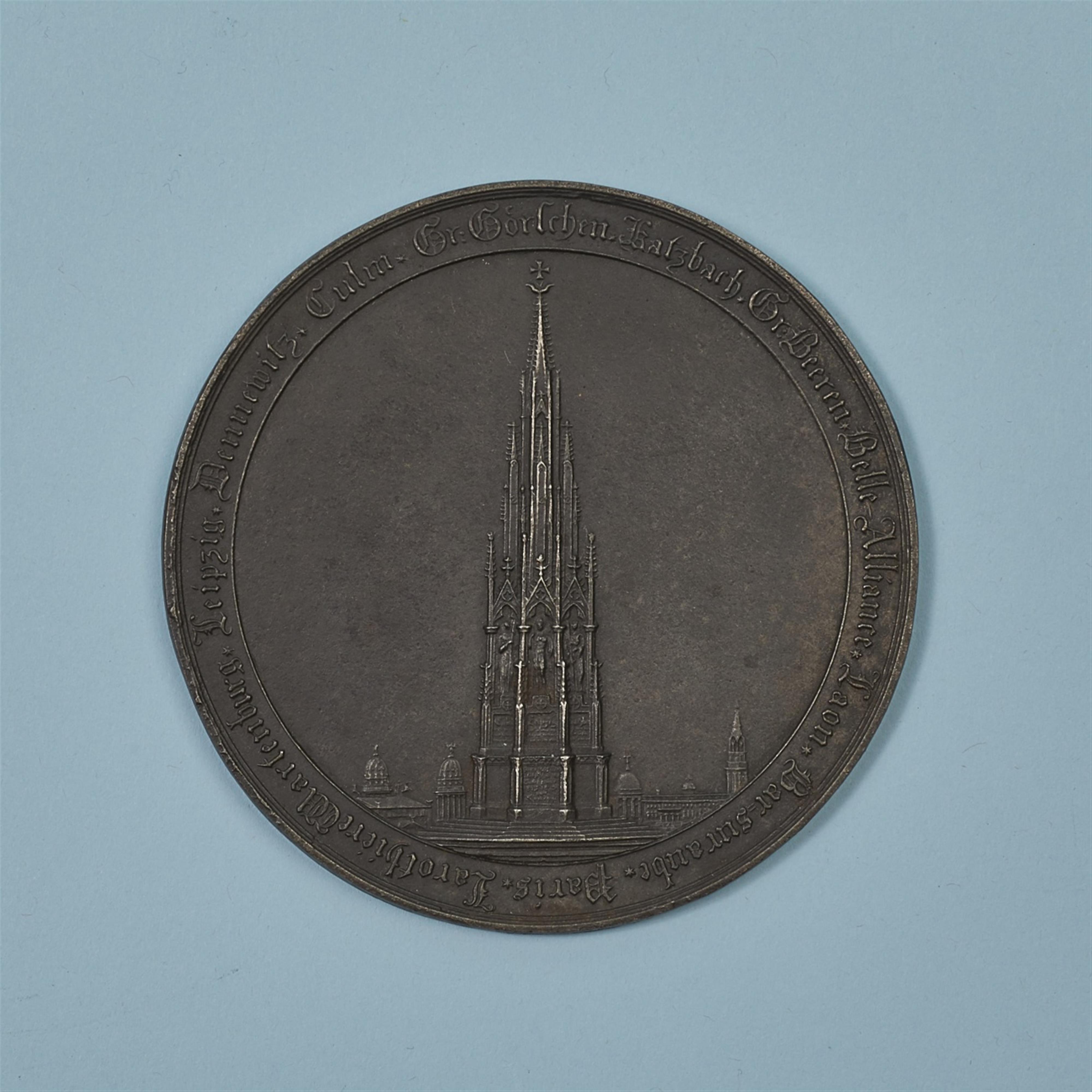 A cast iron medallion with the Kreuzberg Monument - image-1