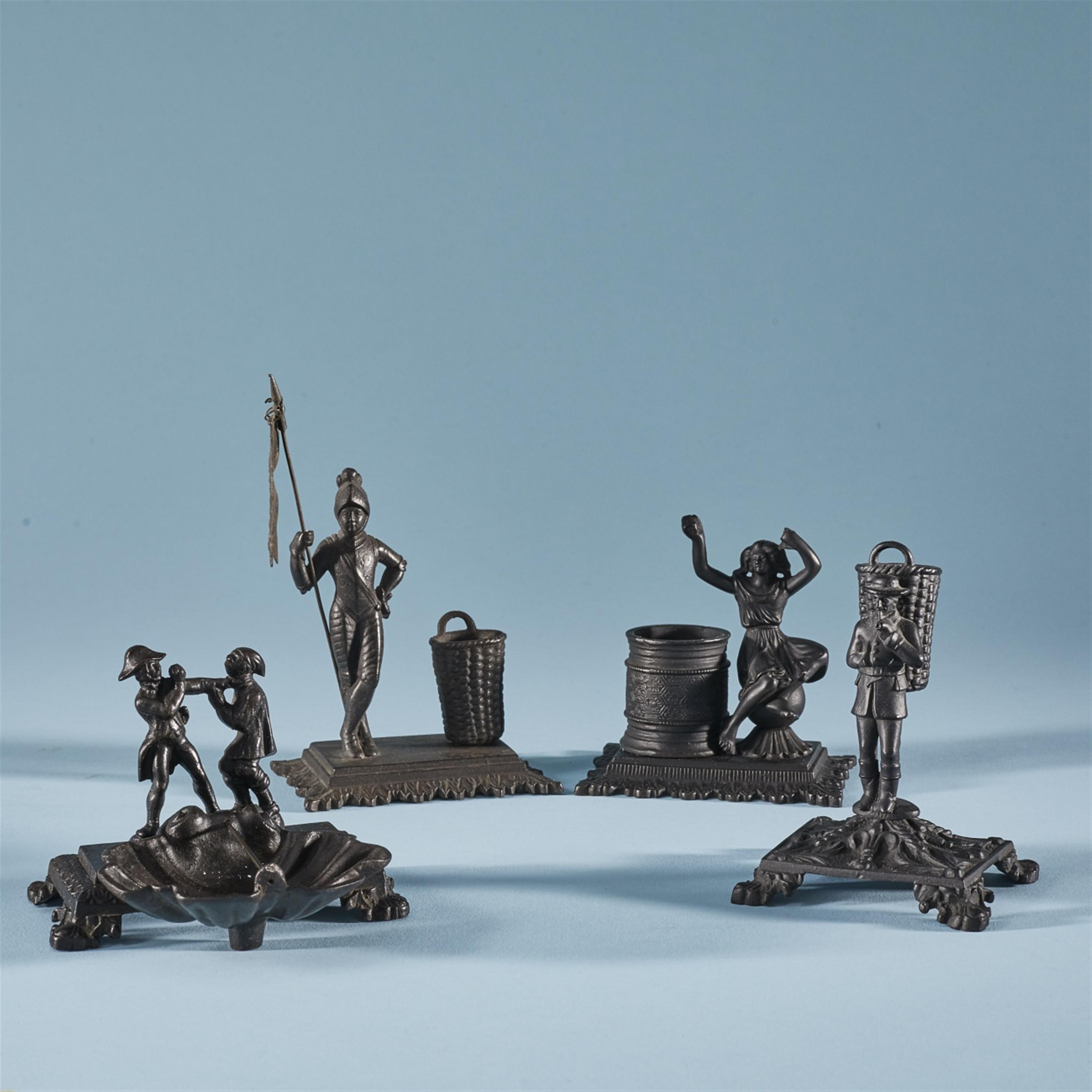 Four small cast iron table accessories - image-1