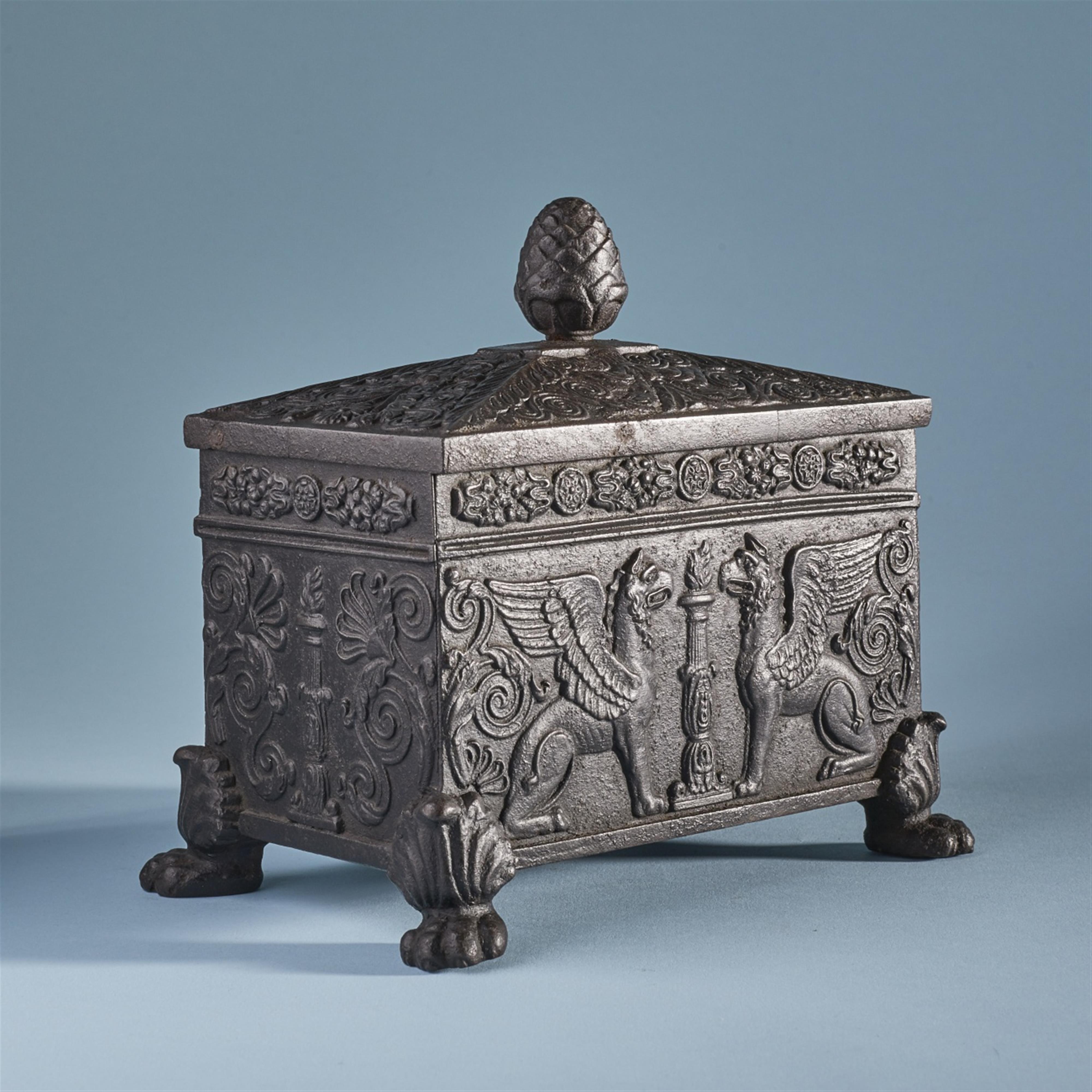 A cast iron tobacco case with griffons - image-2
