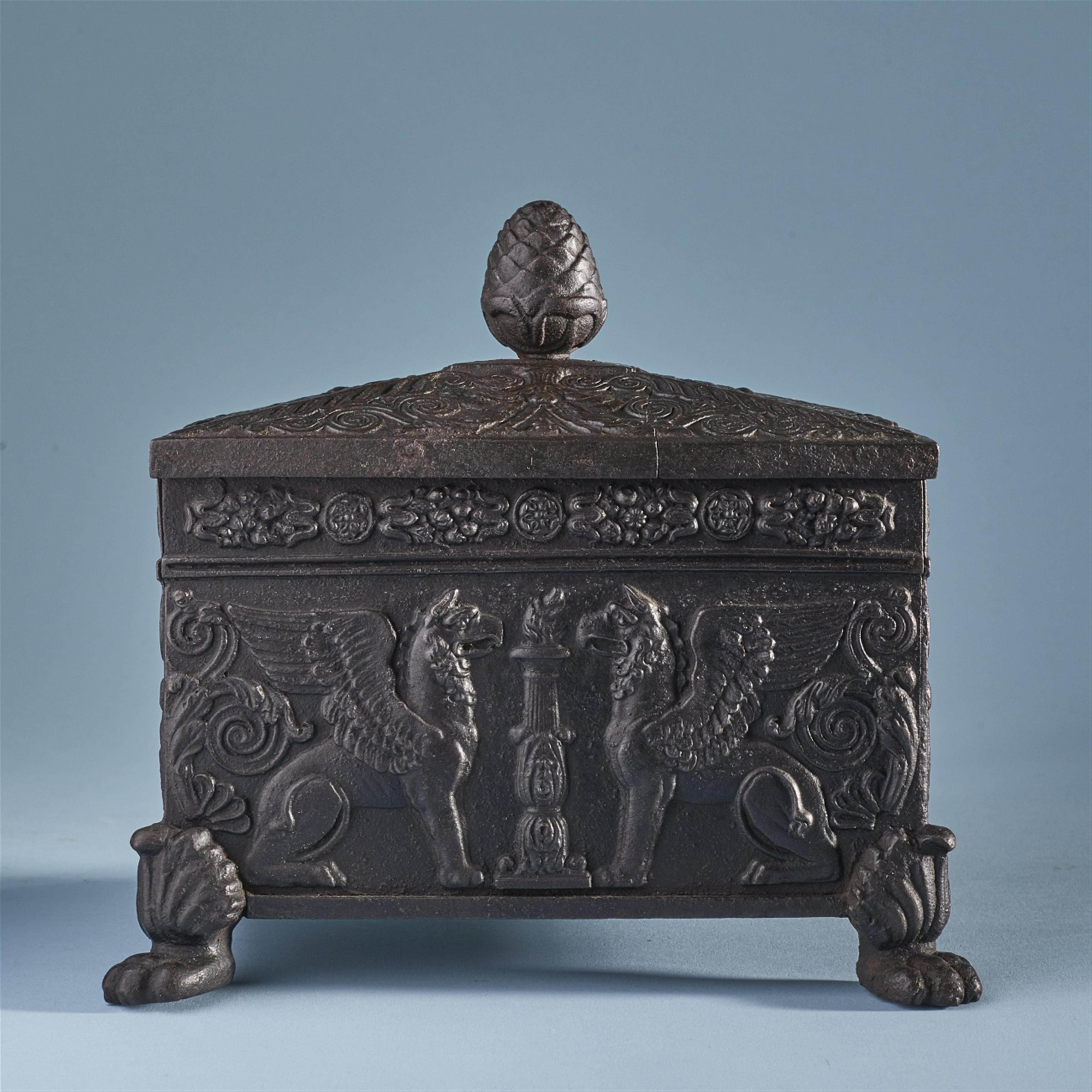 A cast iron tobacco case with griffons - image-1