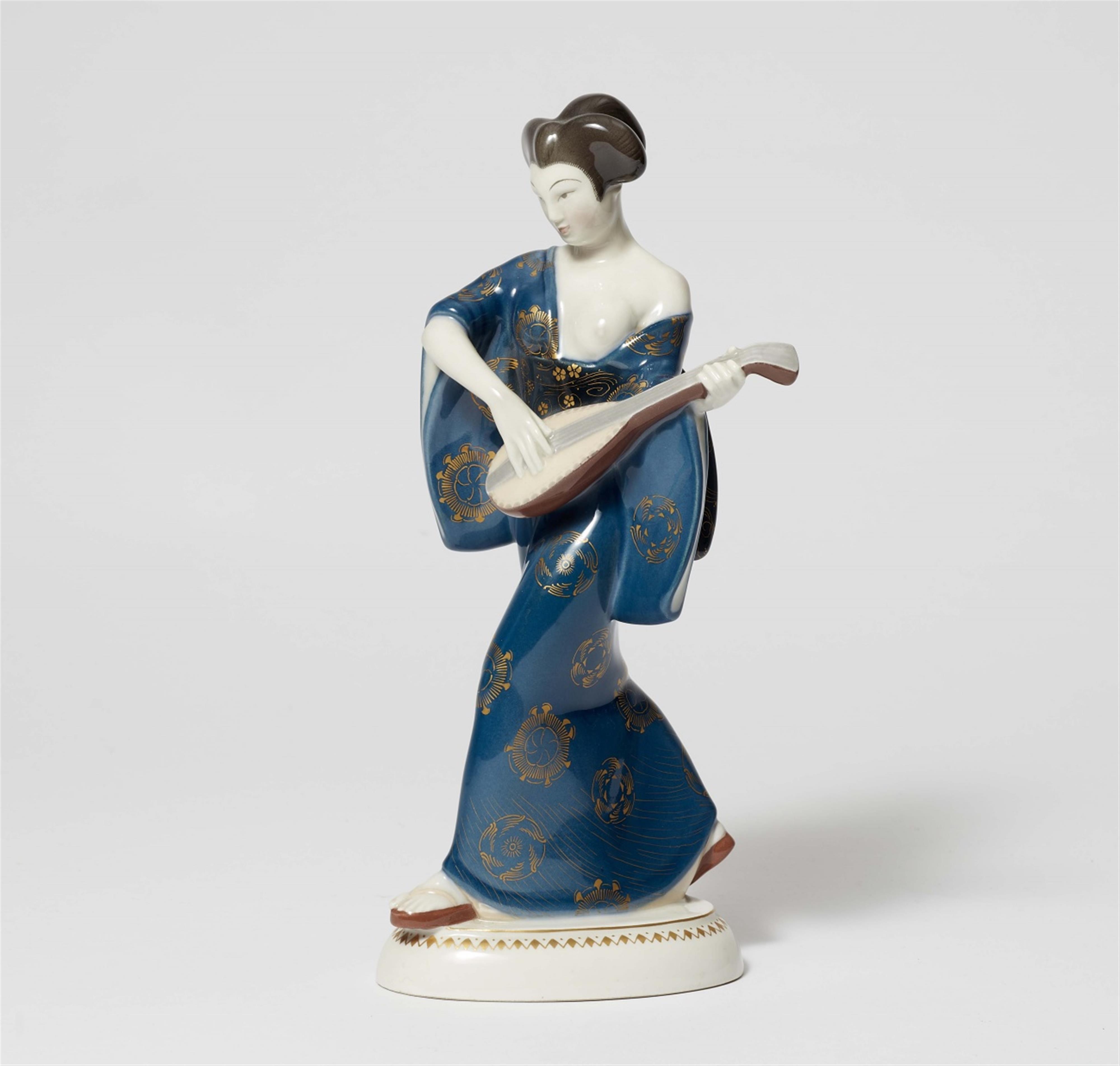A Berlin KPM porcelain model of a Japanese lady with a mandolin from Amberg's centrepiece - image-1