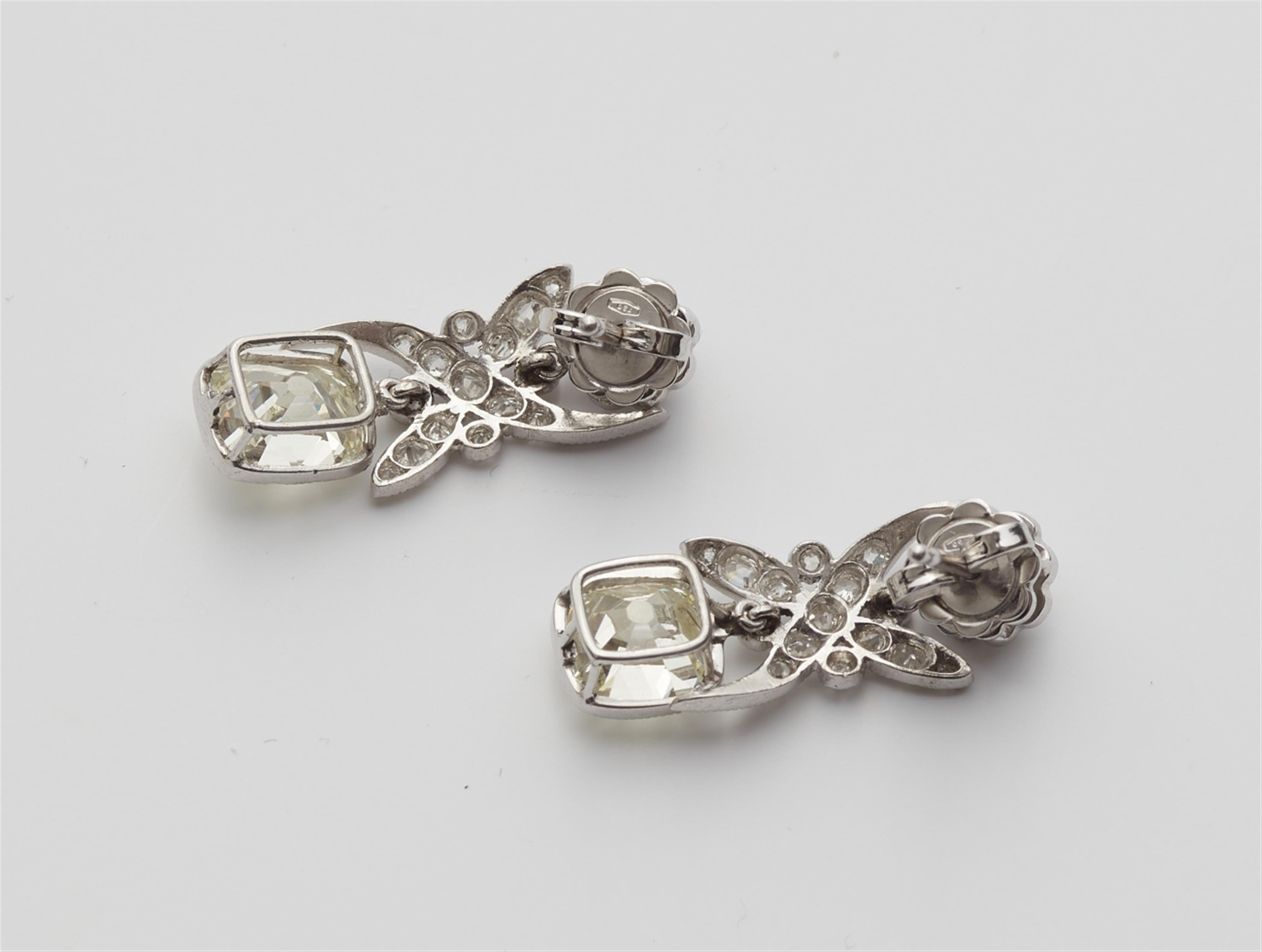 A pair of 14k gold diamond solitaire earrings - image-3