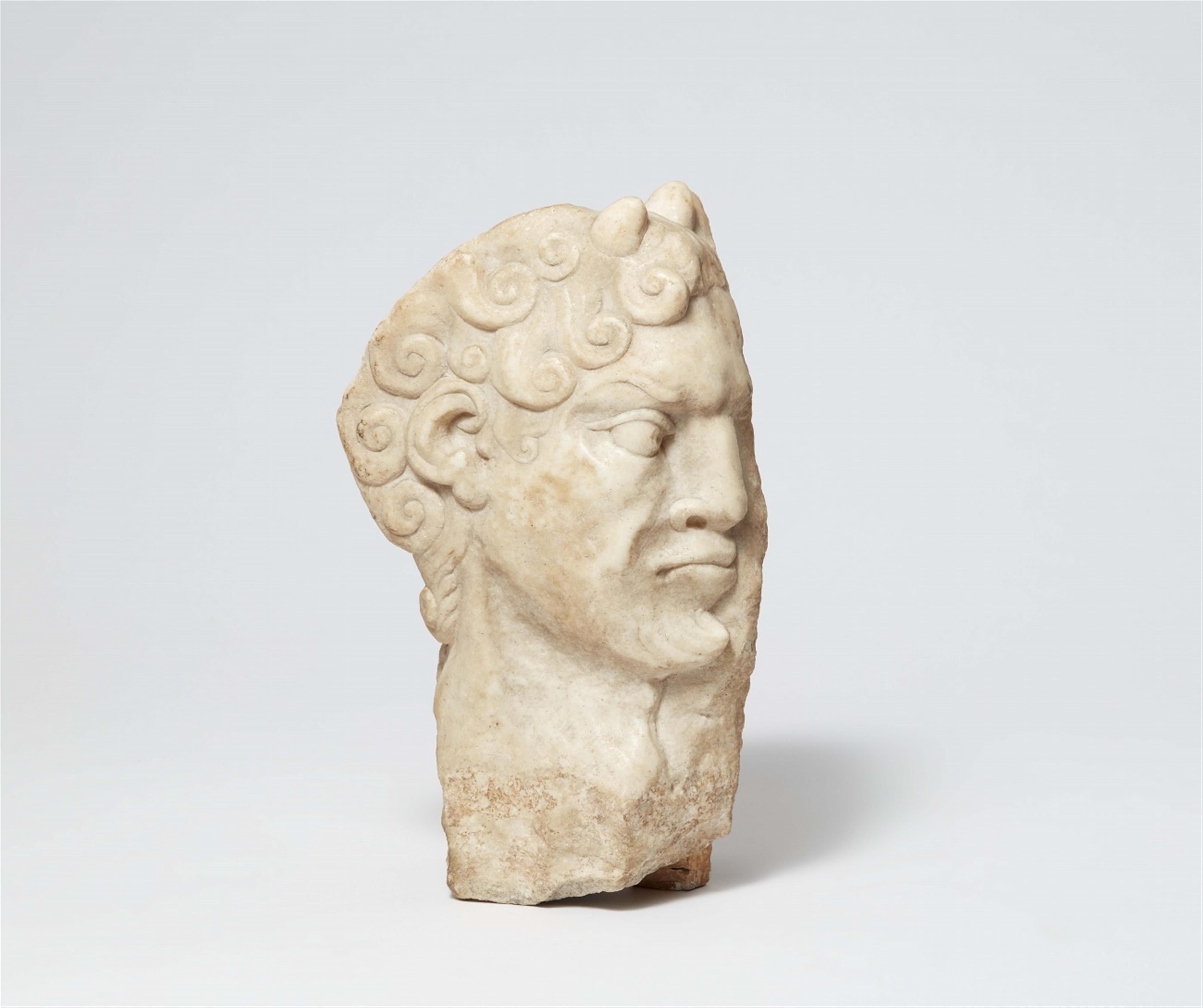 A carved marble head of a faun - image-1