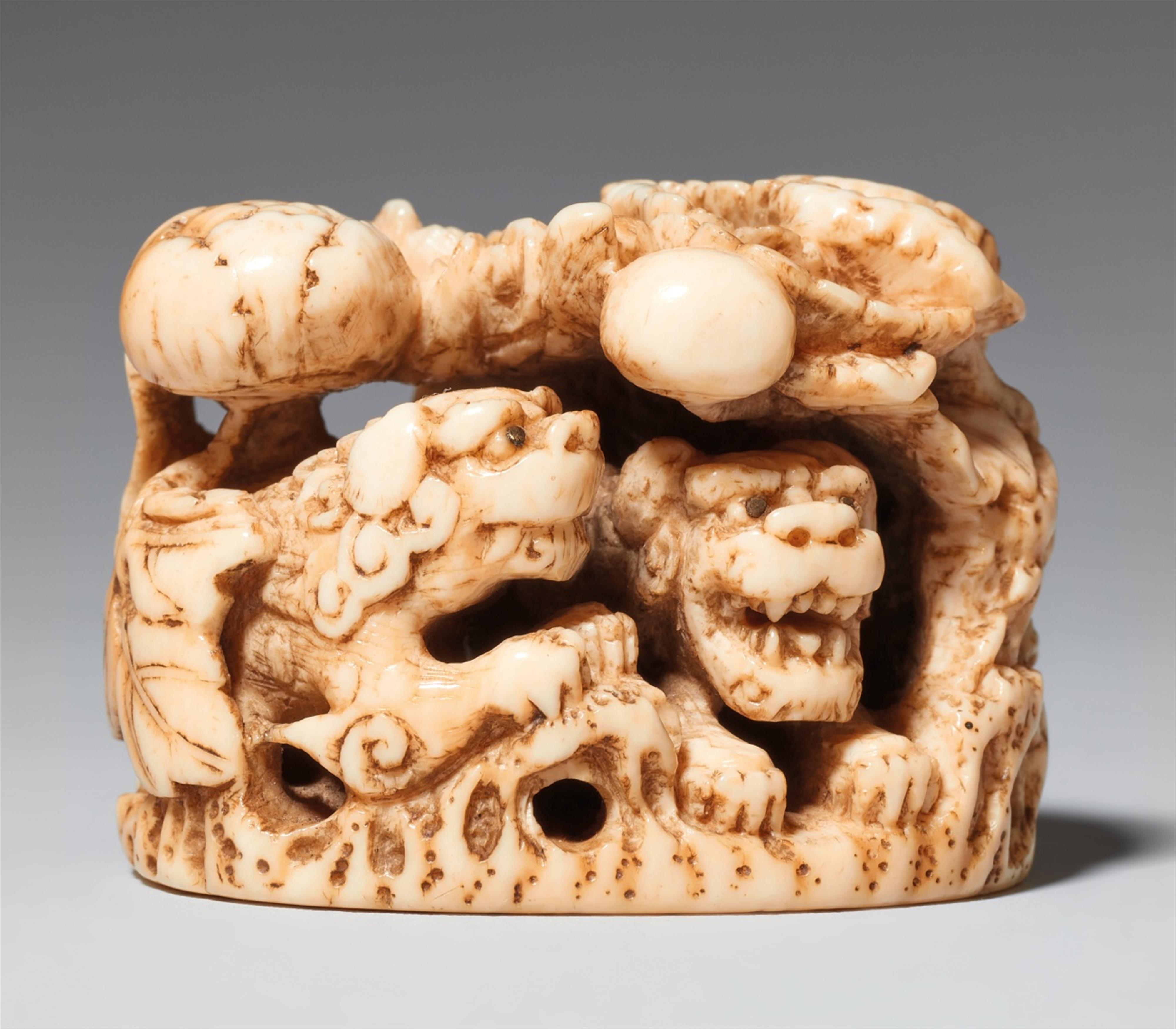 An ivory netsuke of shishi under peonies. Mid-19th century - image-1