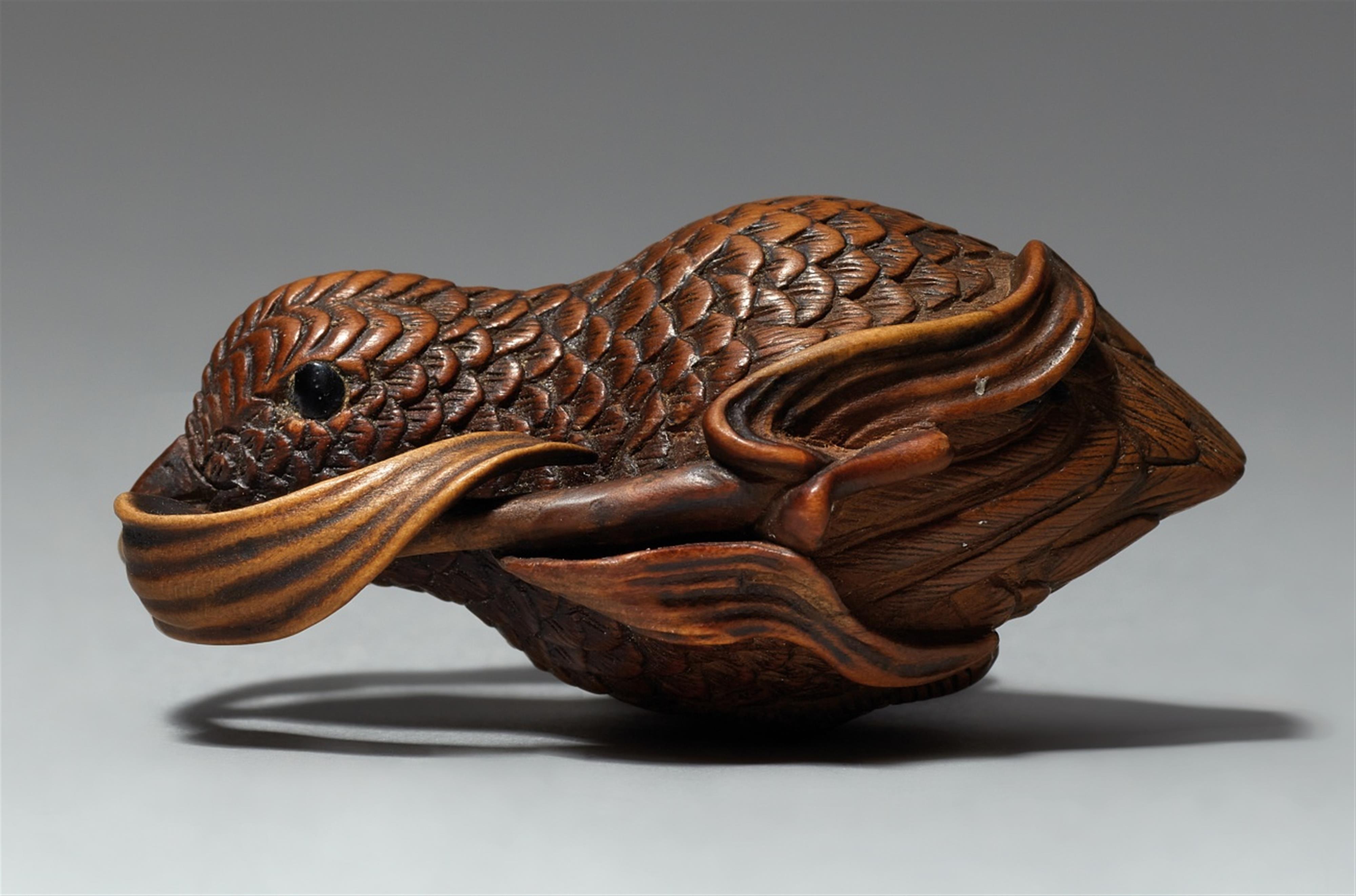 A boxwood netsuke of a flying quail with a millet branch - image-1