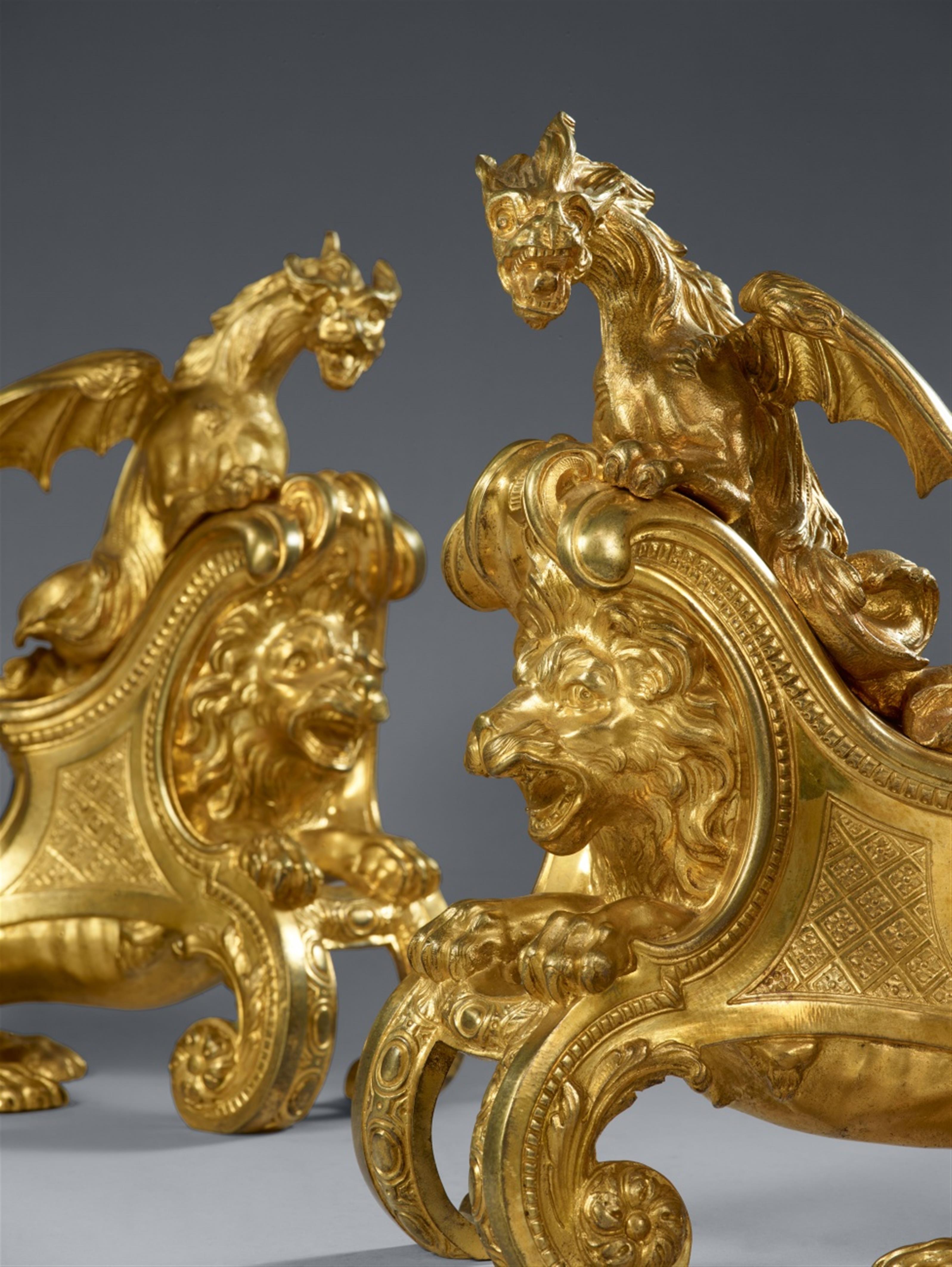 A pair of ormolu fire dogs with lions and dragons - image-2