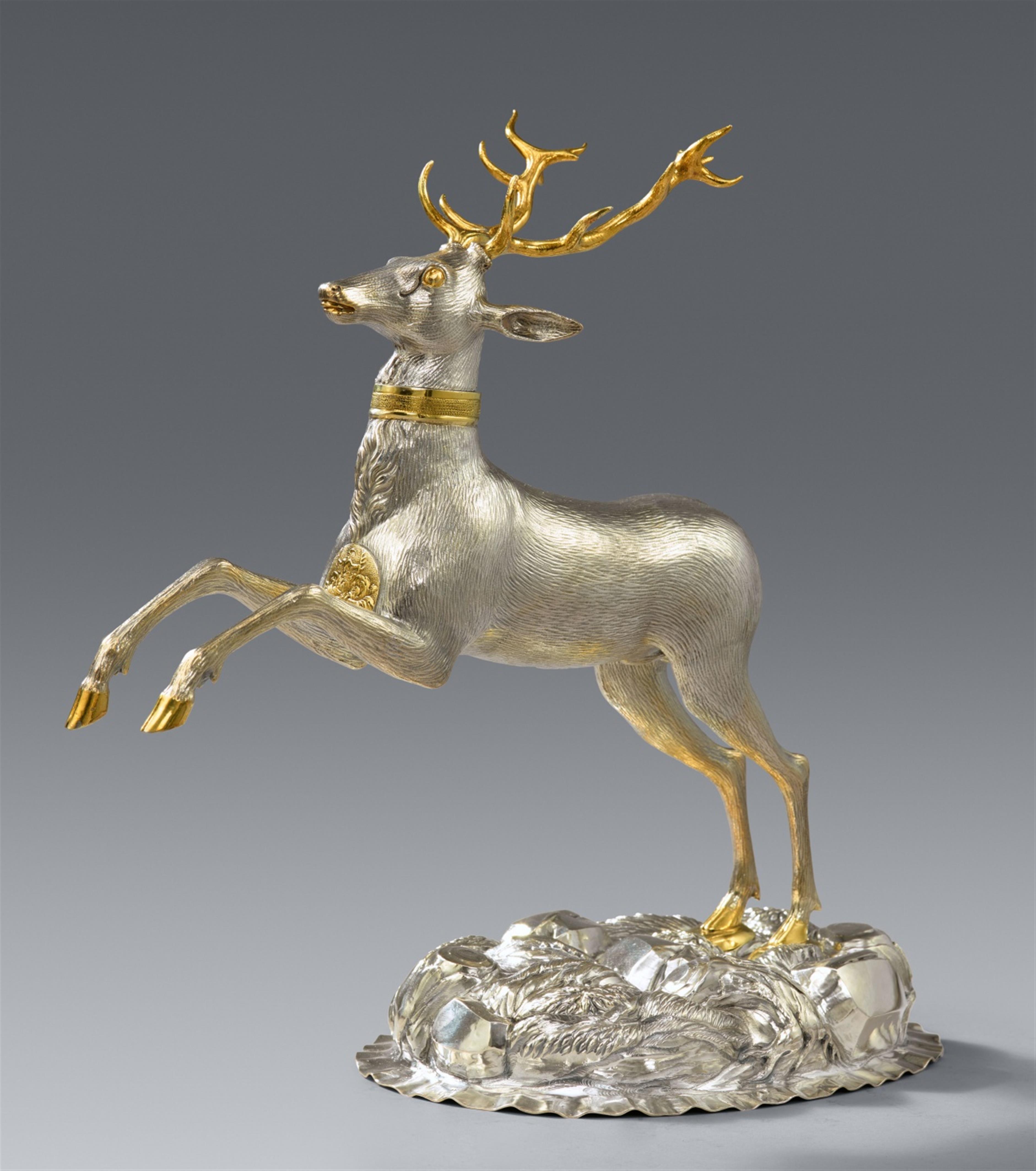 A parcel gilt silver drinking vessel in the form of a stag - image-1