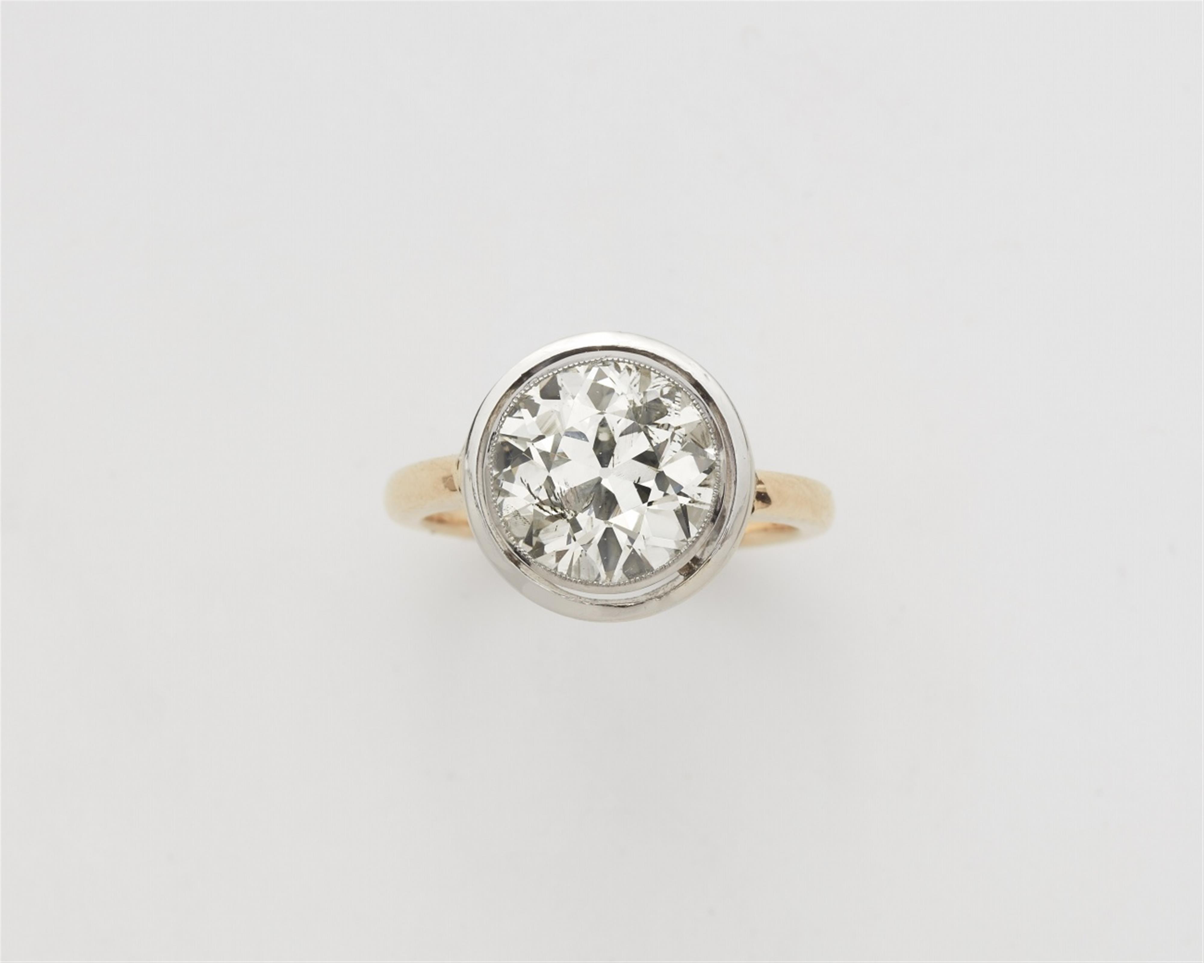 A 14k gold and platinum solitaire ring with a European old-cut diamond - image-1