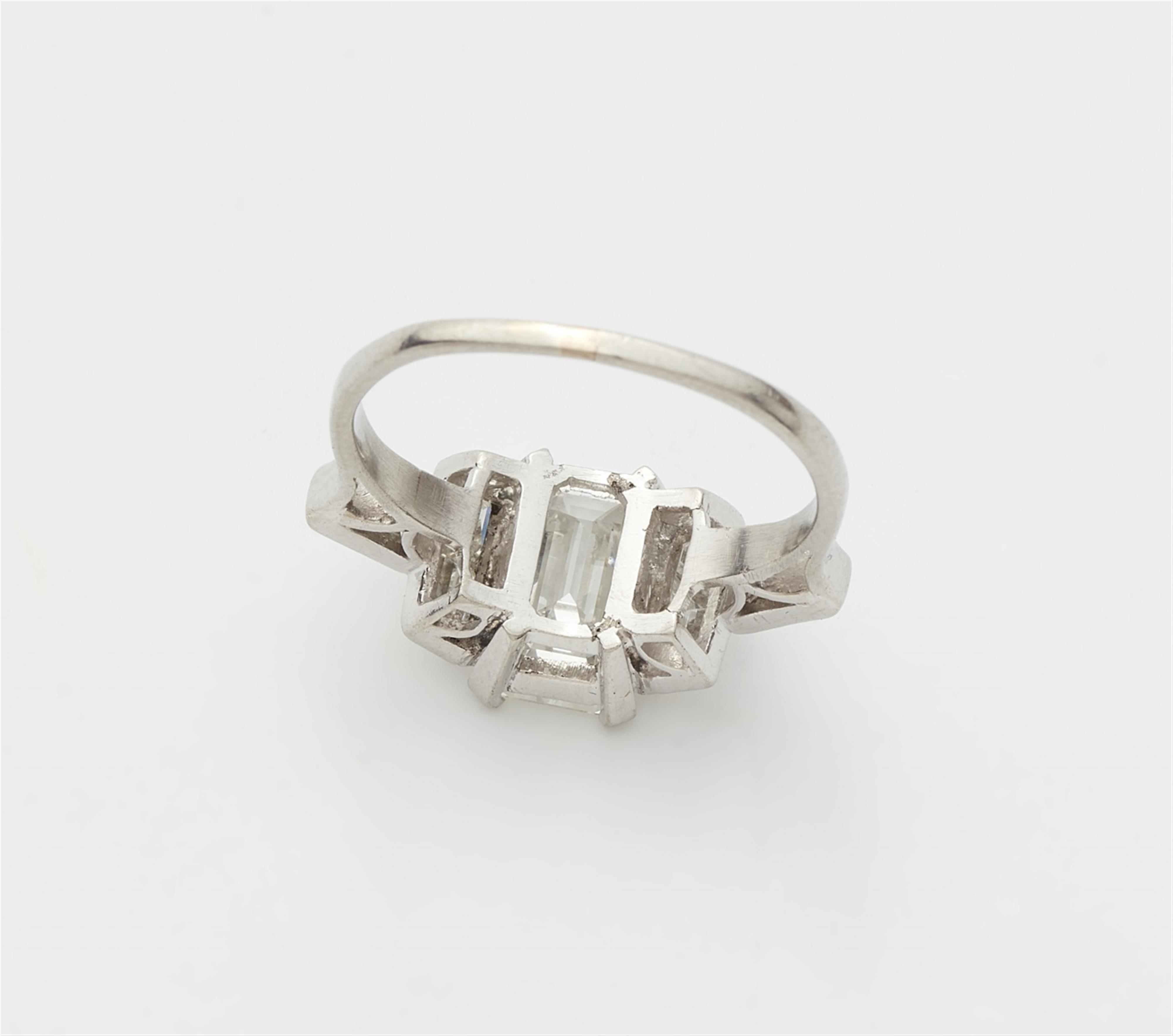 A platinum diamond ring with an emerald-cut diamond solitaire - image-2