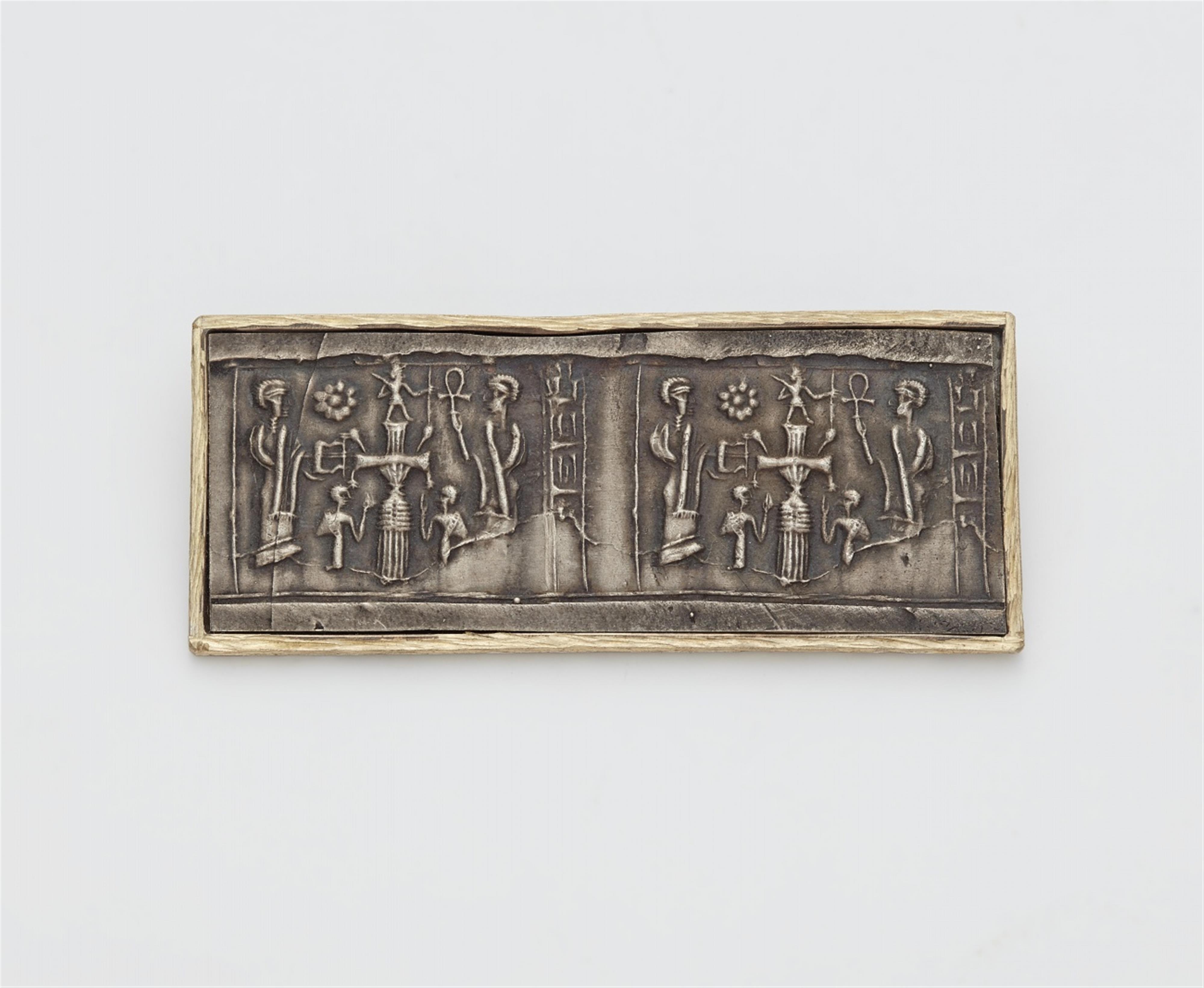 A parcel gilt silver brooch with a cylinder seal impression - image-1