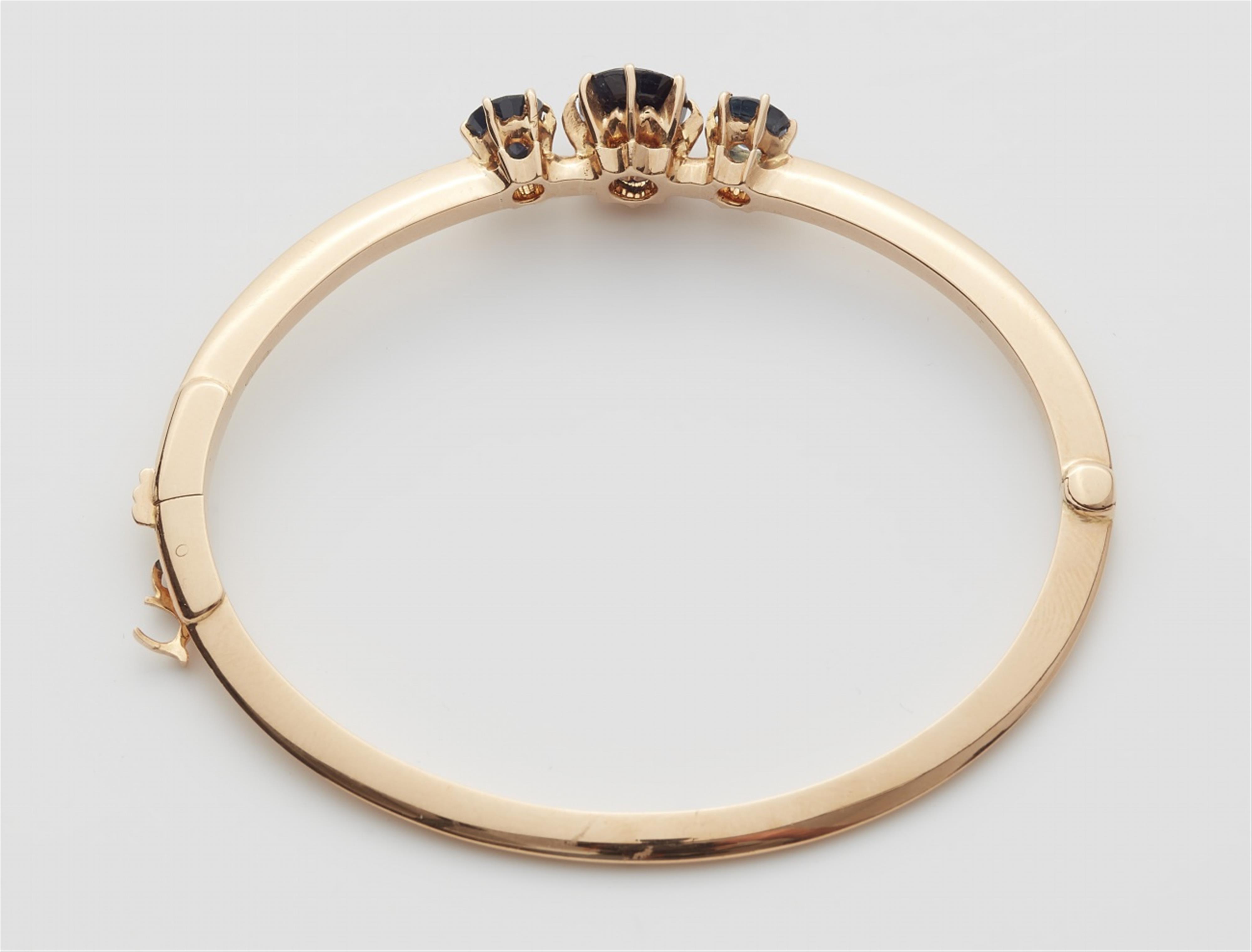 A Belle Epoque 18k red gold sapphire bangle - image-2