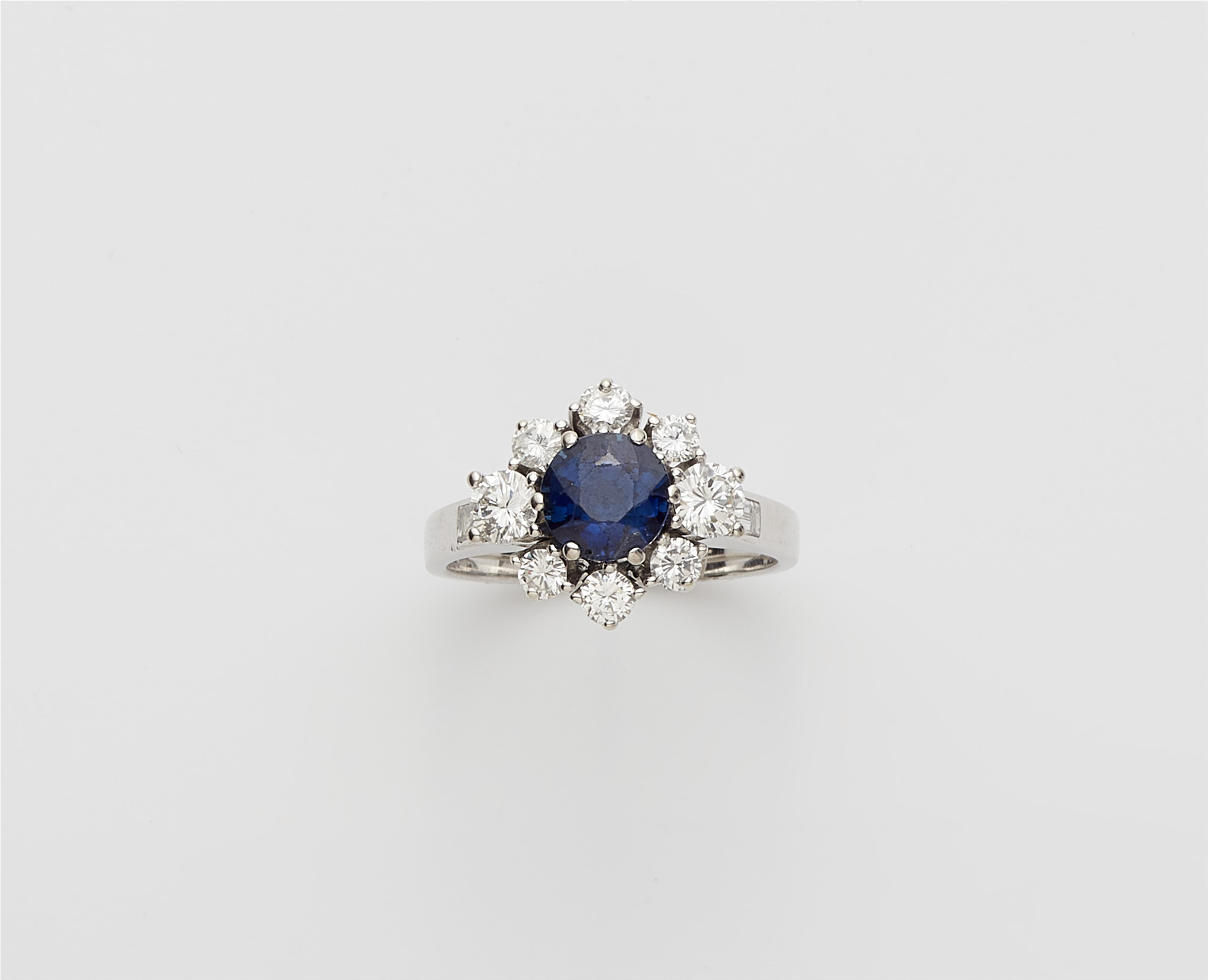 A German 18k white gold sapphire and diamond cluster ring. - image-1