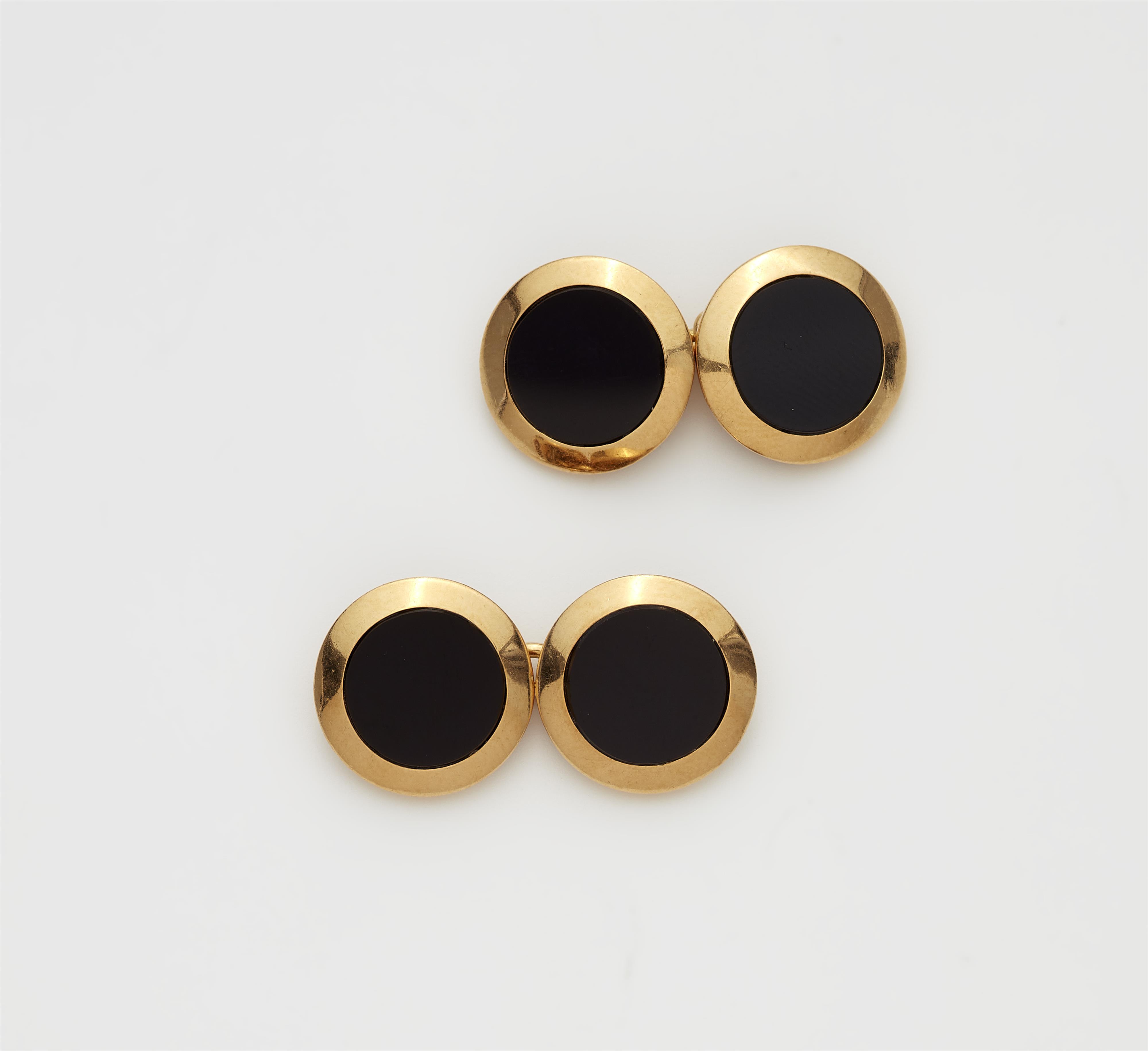 A pair of French 18k gold and onyx cufflinks. - image-1