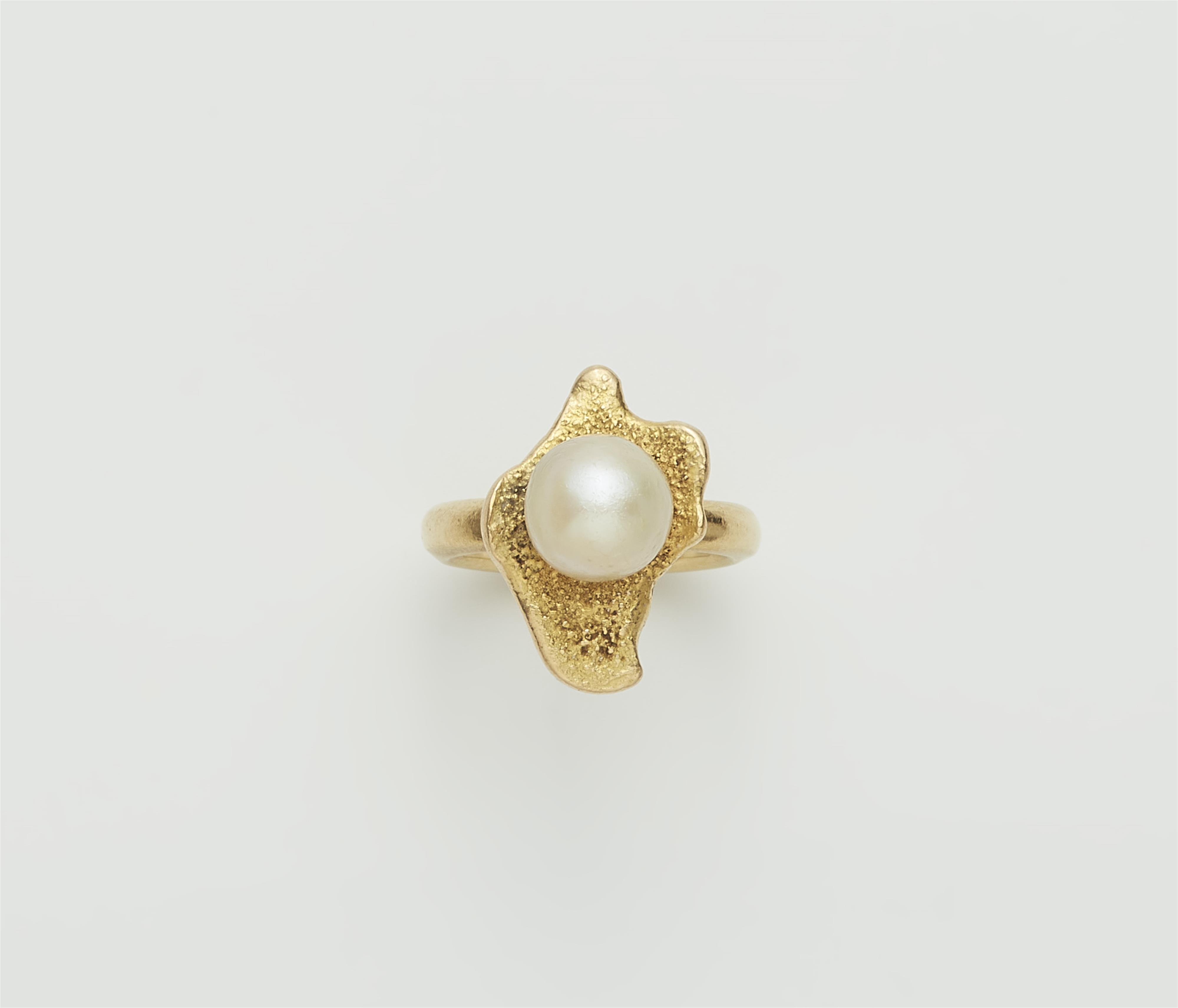 An 18k gold and cultured pearl ring. - image-1