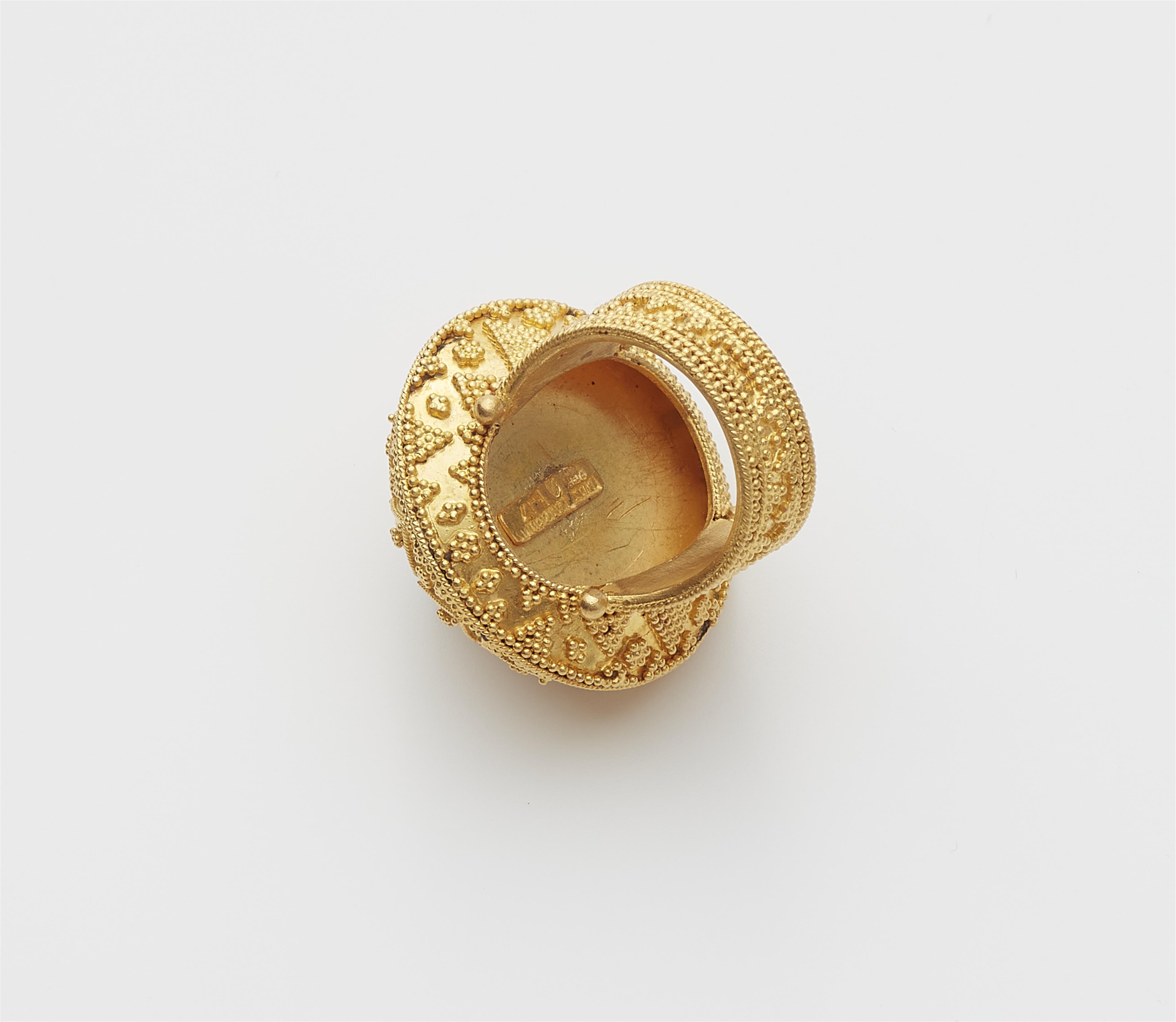 A Greek 18k gold and emerald Hellenistic style buckle ring. - image-2