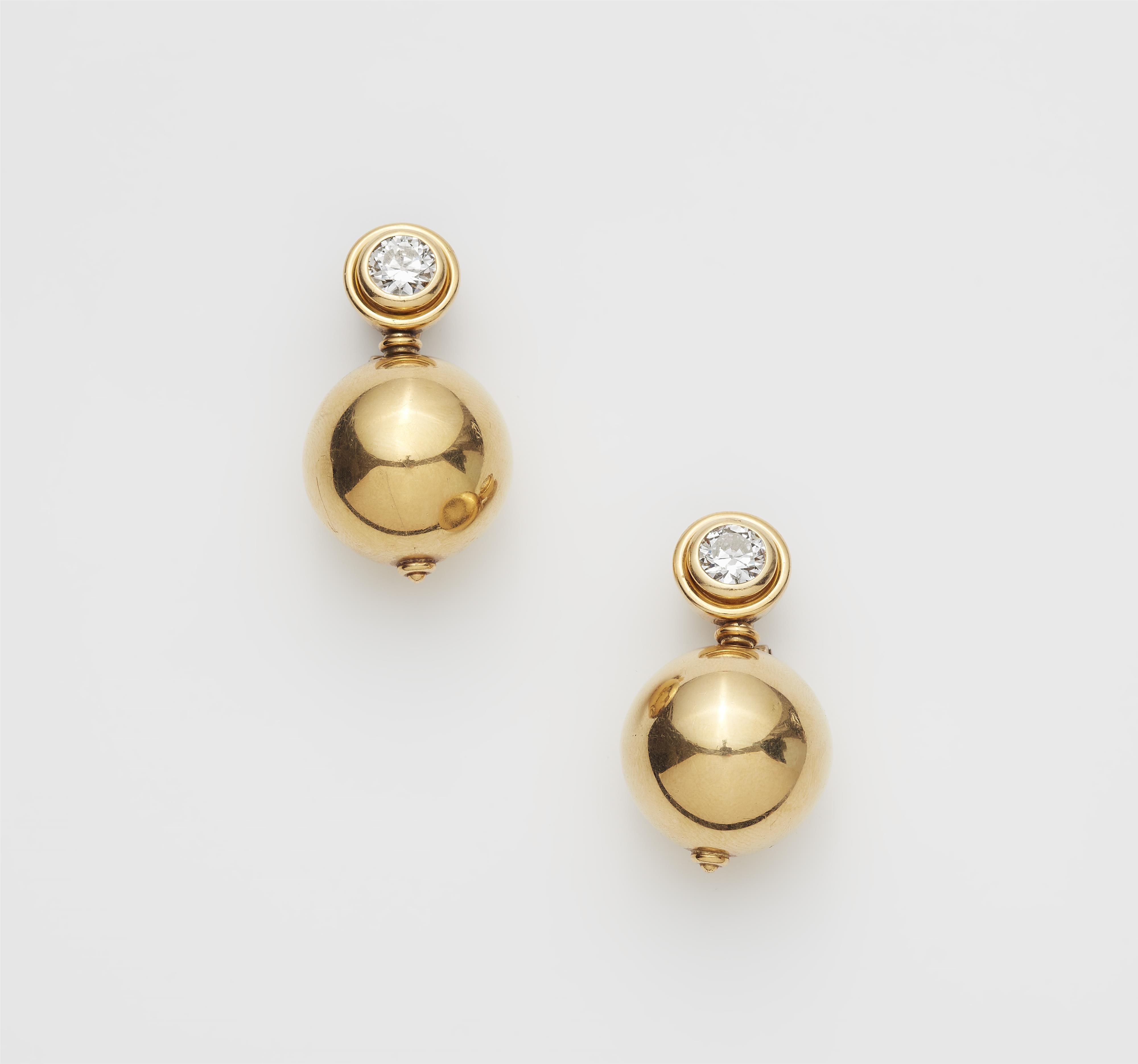 A pair of German 18k yellow gold and diamond solitaire clip earrings. - image-1