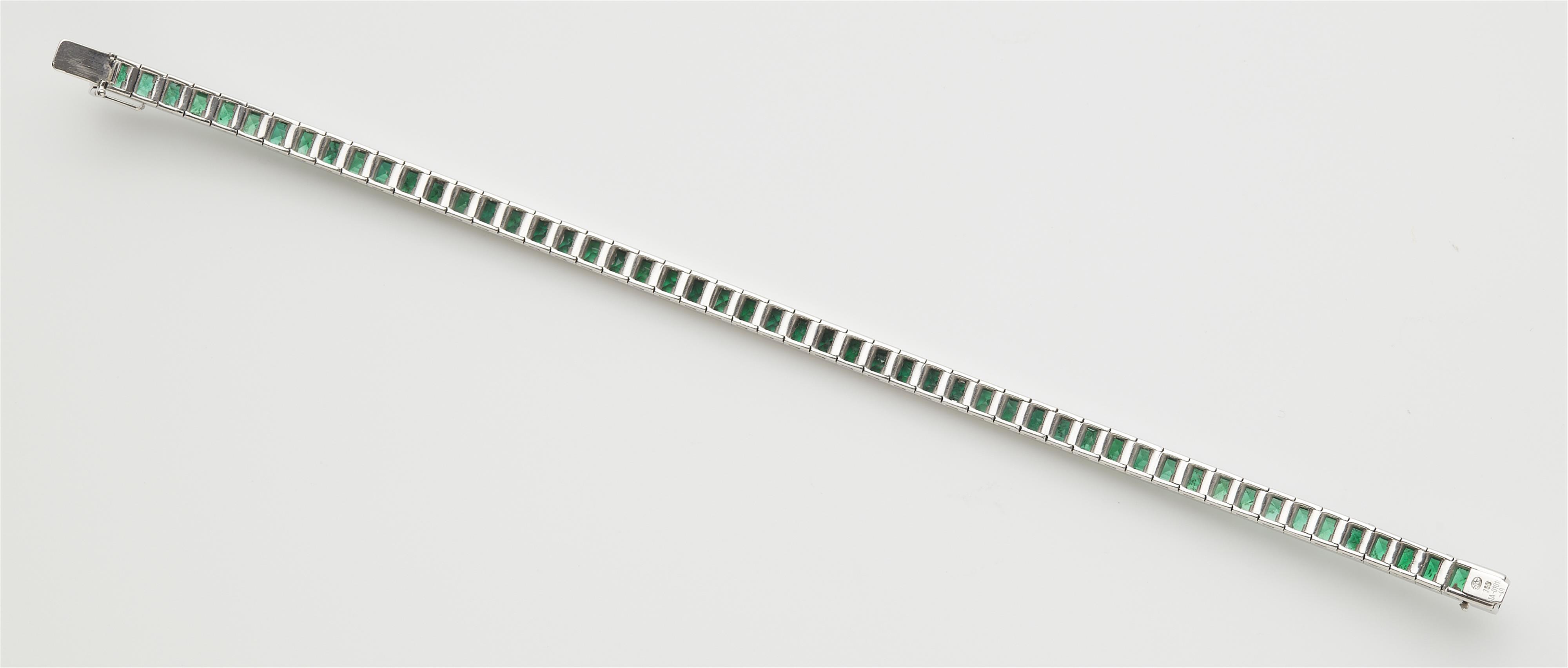 An 18k white gold and carré-cut emerald rivière bracelet. - image-2