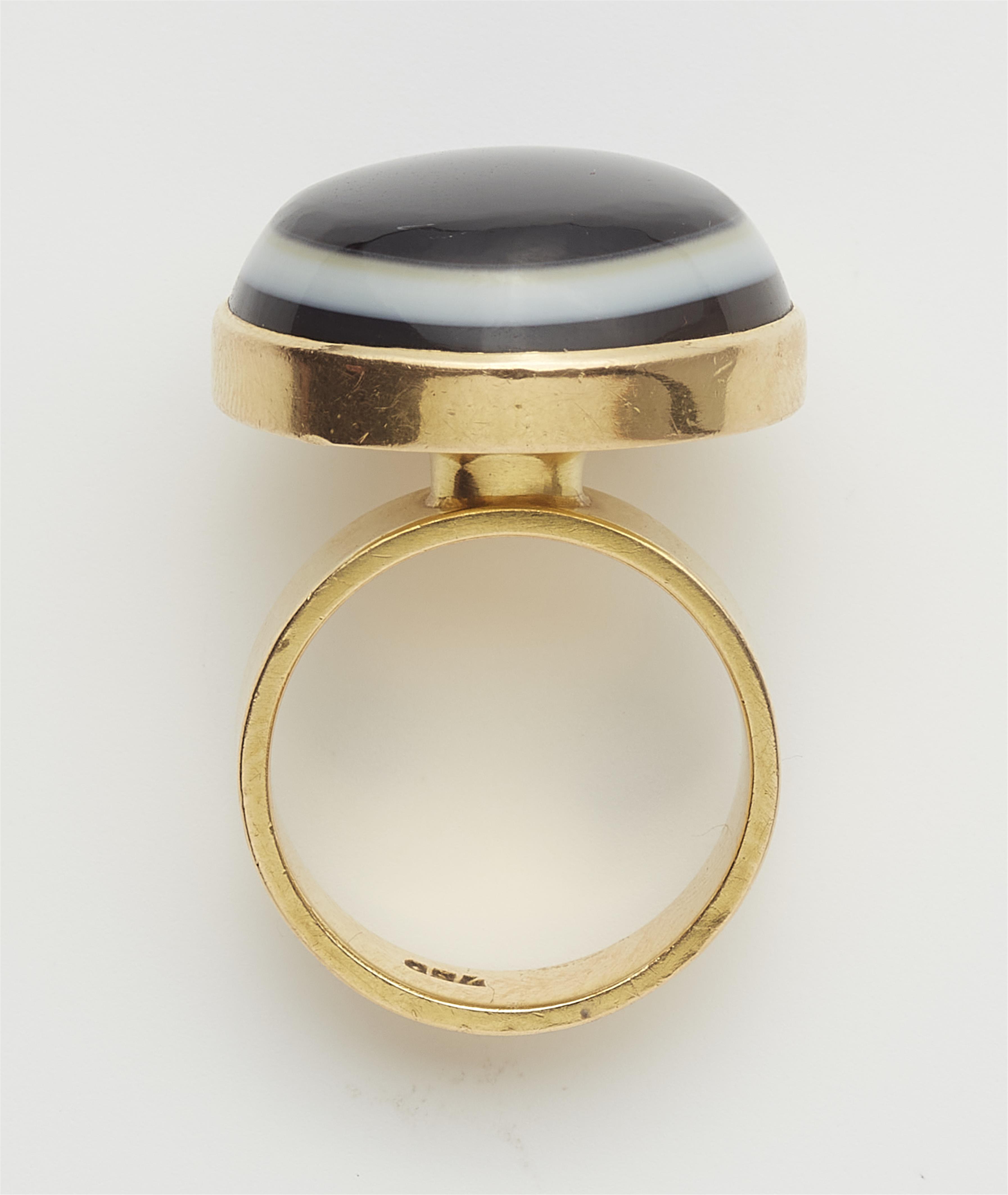 An 18k gold and eye agate cabochon ring. - image-2