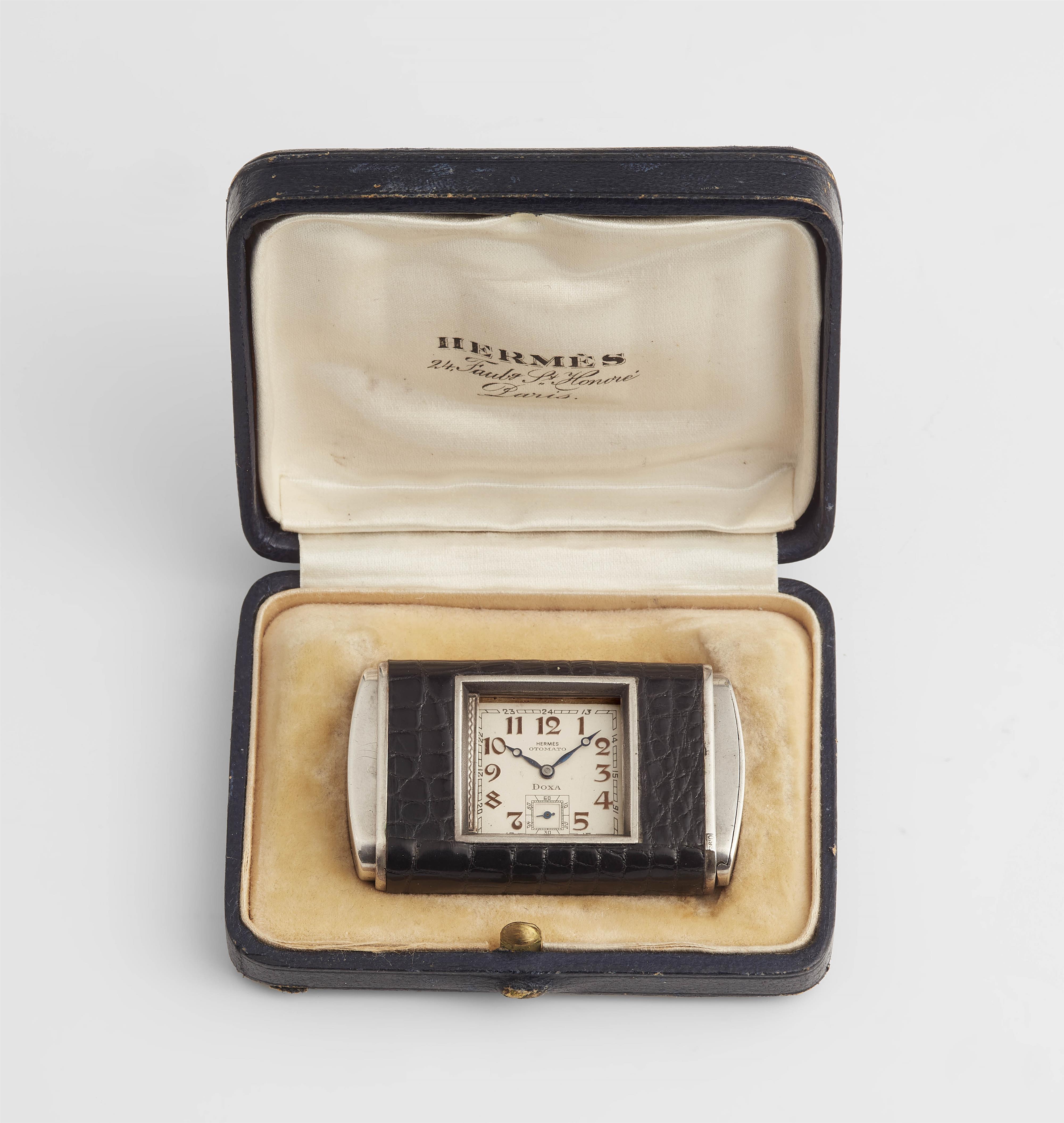 A silver Hermès Otomato travel watch with Doxa movement. - image-1