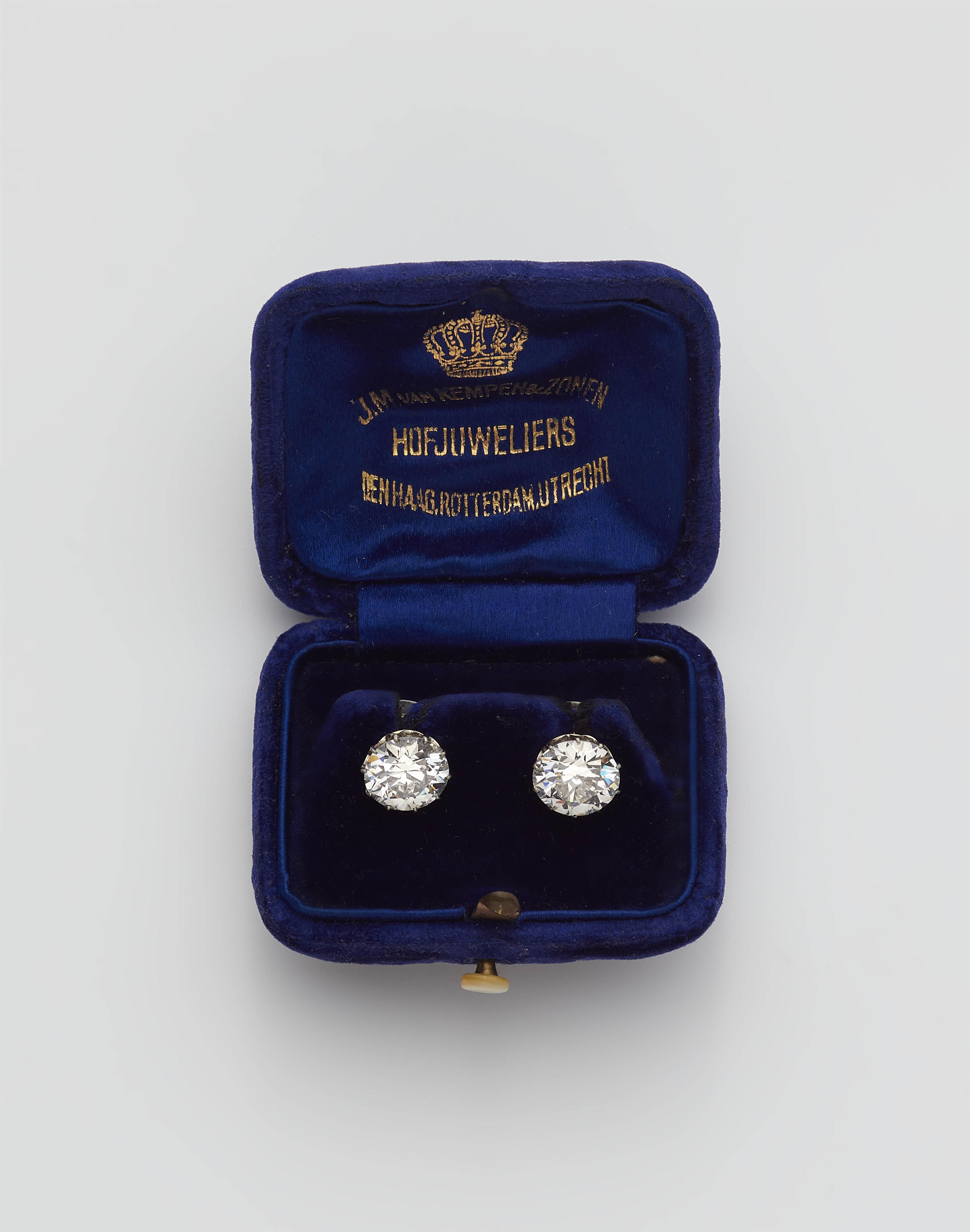 A pair of 14k gold and transition-cut diamond solitaire stud earrings. - image-1