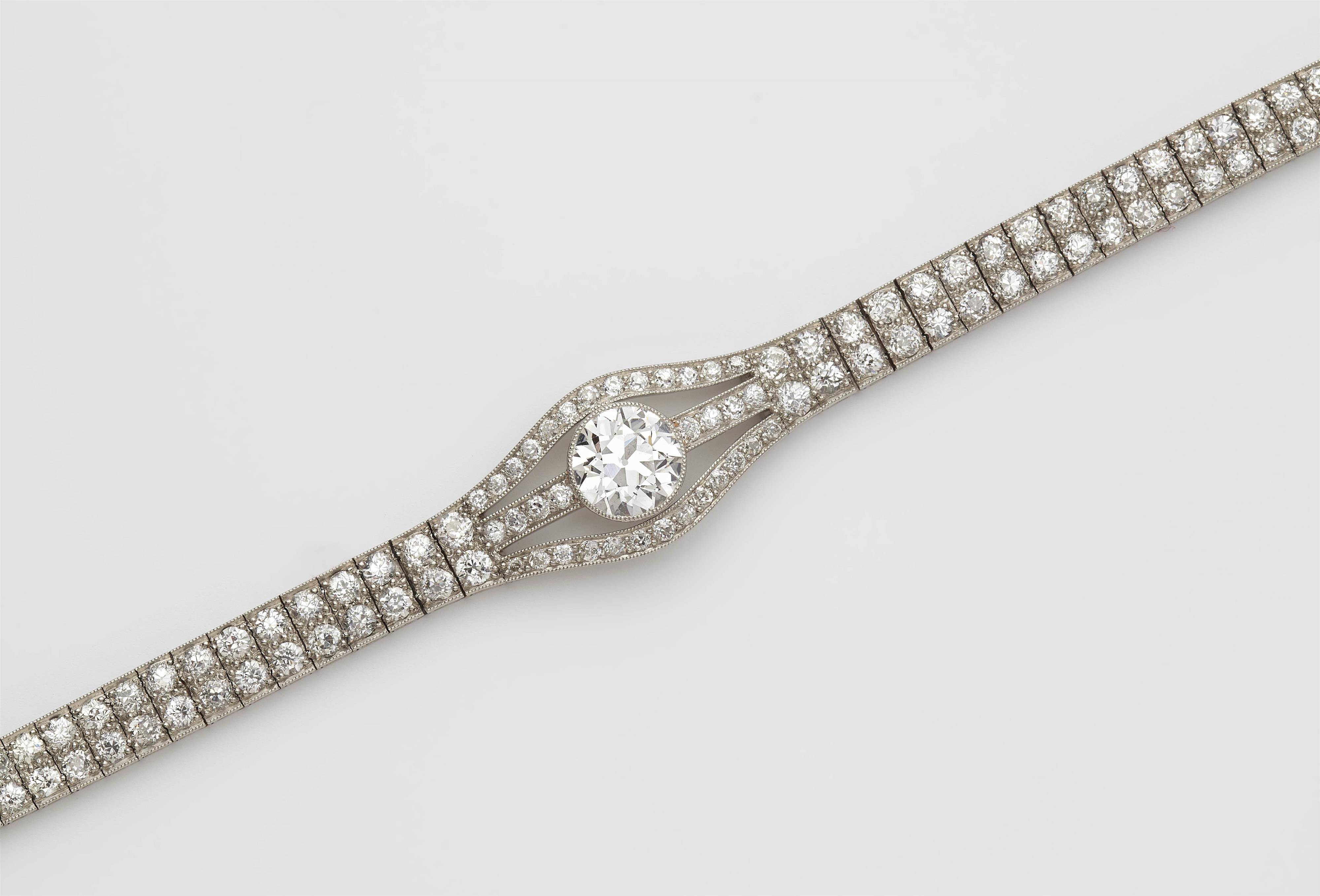 An Art Deco platinum and diamond bracelet with a transition-cut diamond solitaire of ca. 2.15 ct. - image-2