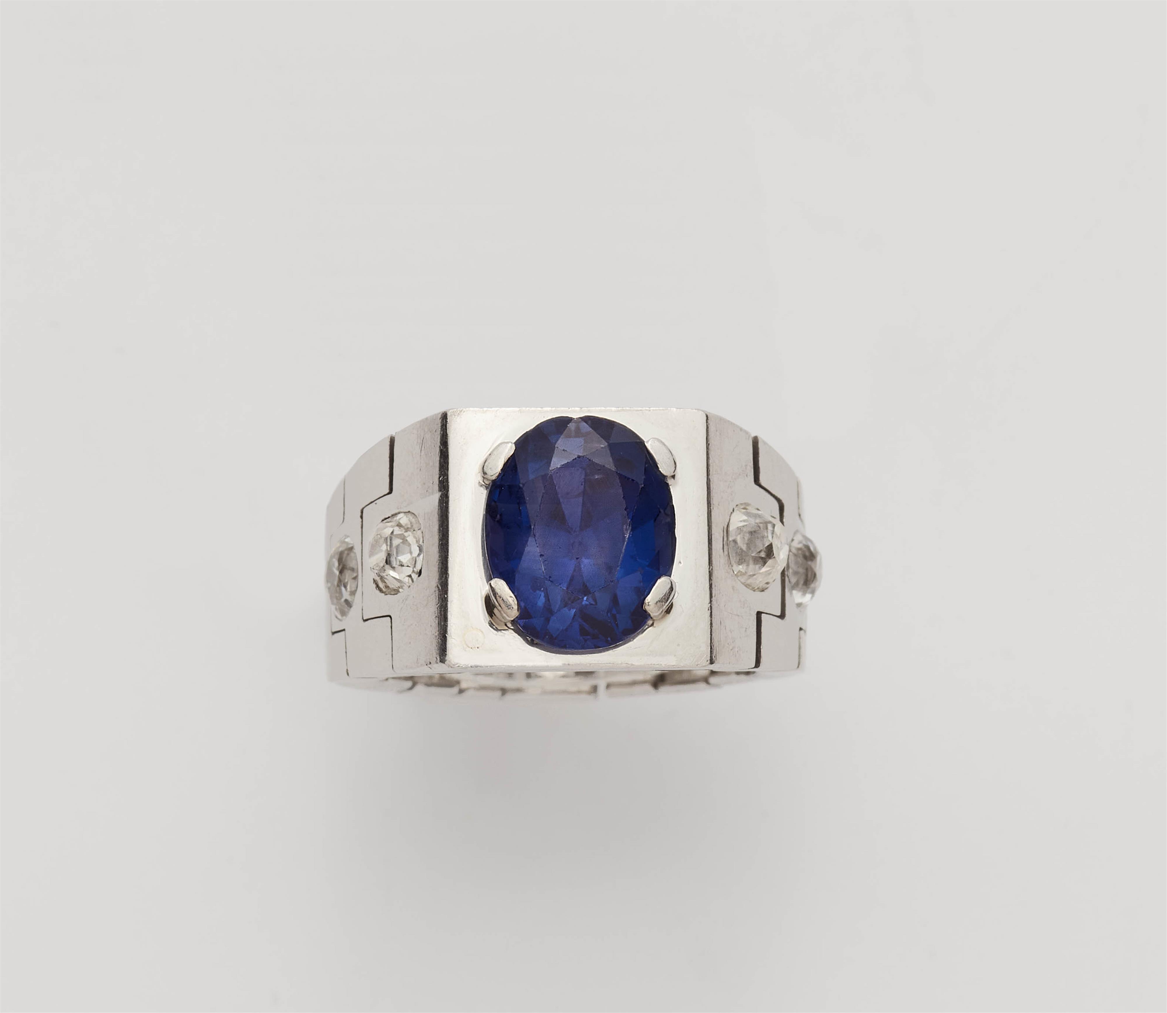 A French Art Deco platinum diamond chain ring with a rare colour change Ceylon sapphire. - image-1