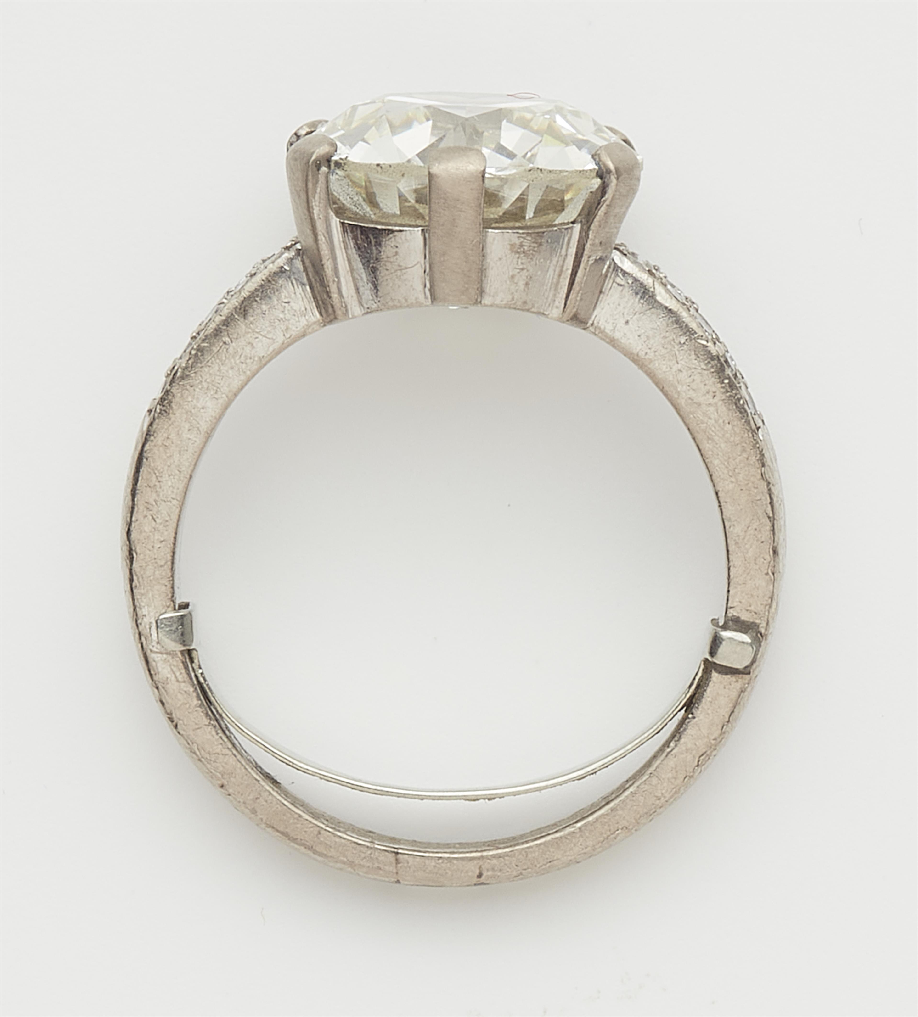 An 18k gold 6.54 ct transition-cut diamond solitaire ring. - image-5